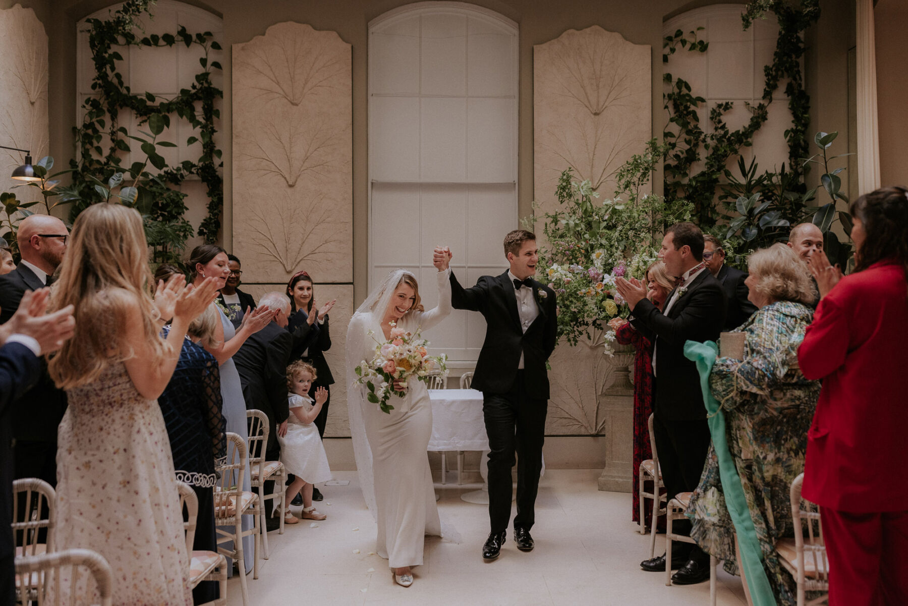 Bride and groom celebrating becoming married at Spring in Somerset House, London. Maja Tsolo Photography.