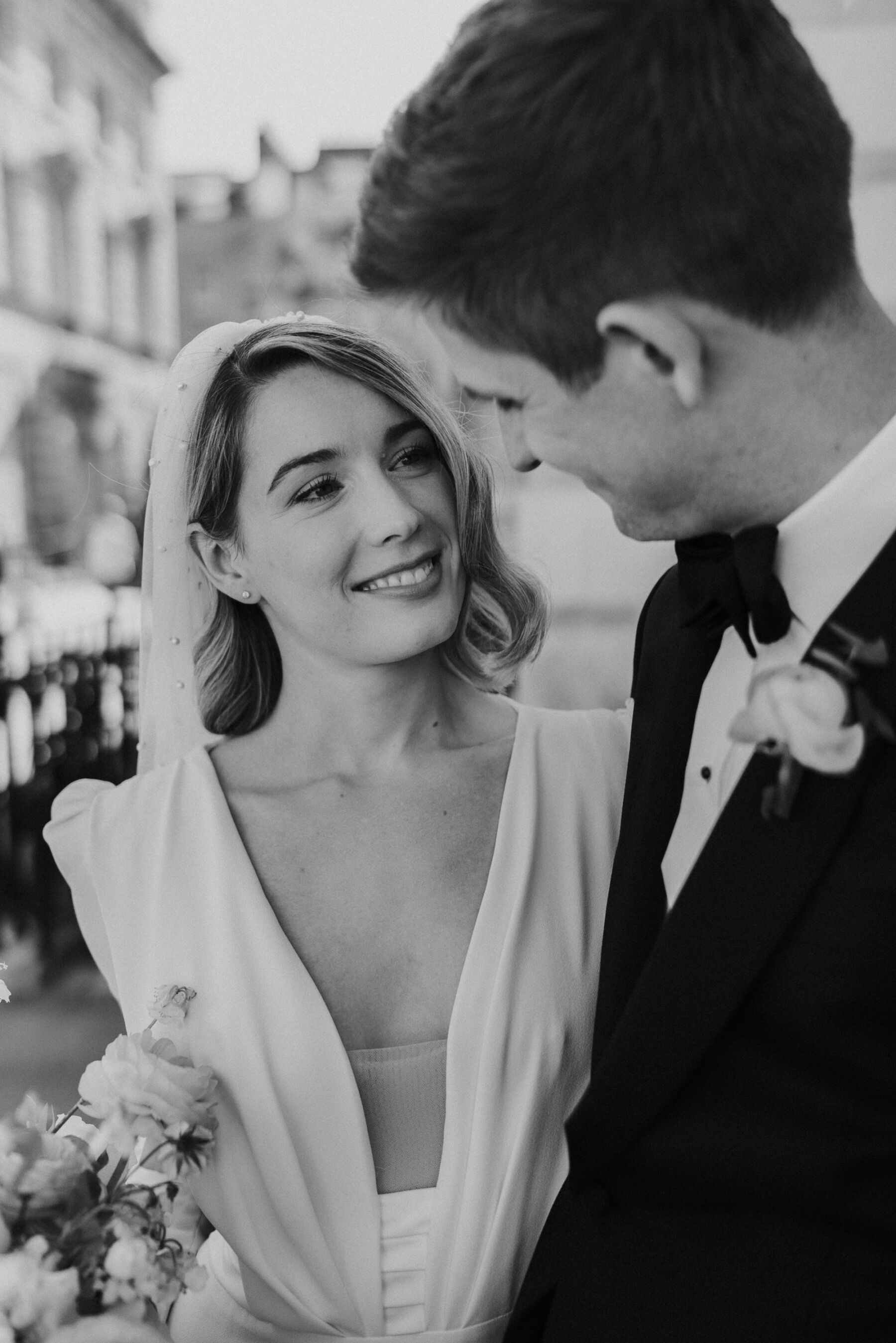 Black and white image of modern bride in the Adrienne dress by Pronovias with puff sleeves and plunge neck. Maja Tsolo Photography.