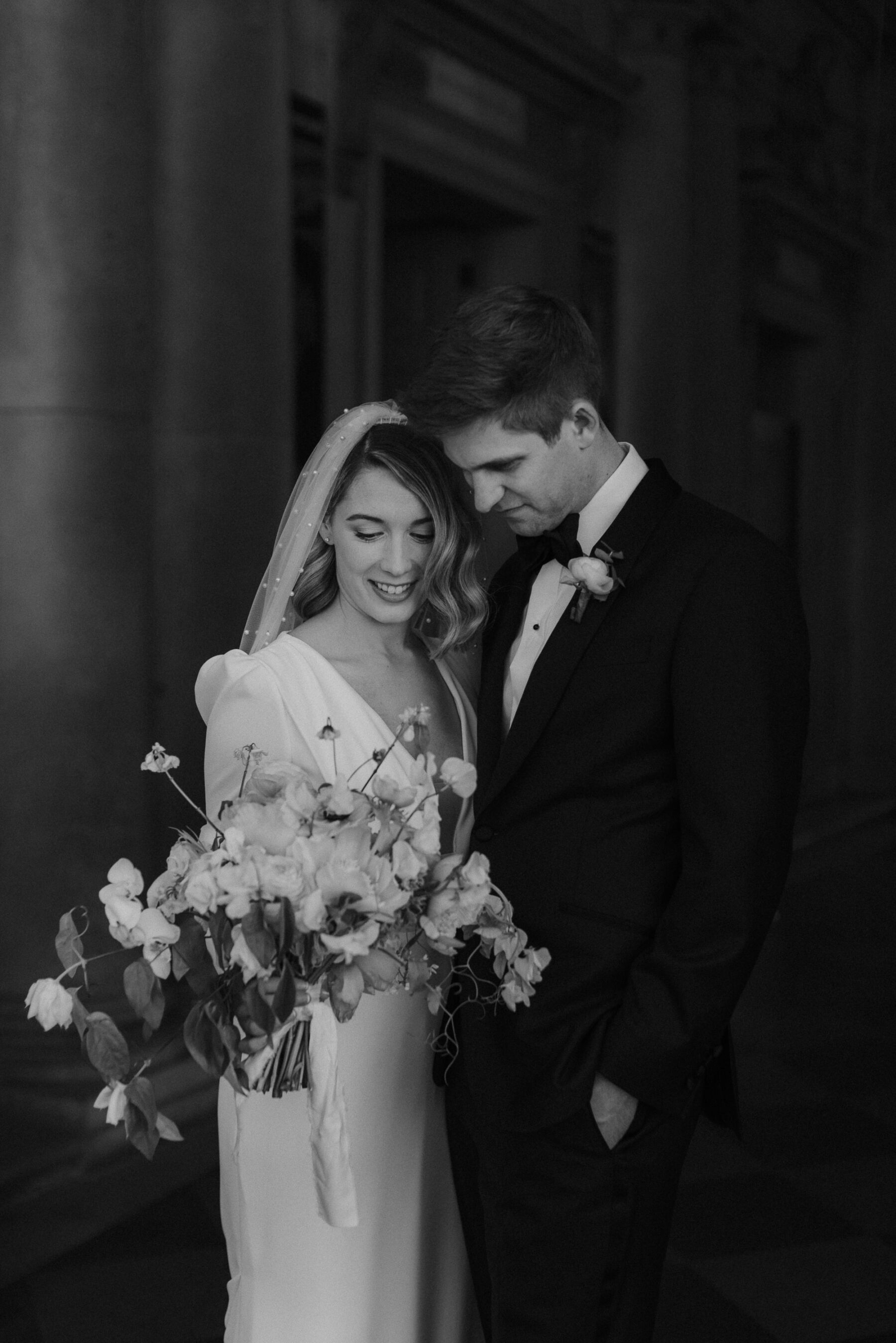 Black and white image of modern bride in the Adrienne dress by Pronovias with puff sleeves. Maja Tsolo Photography.