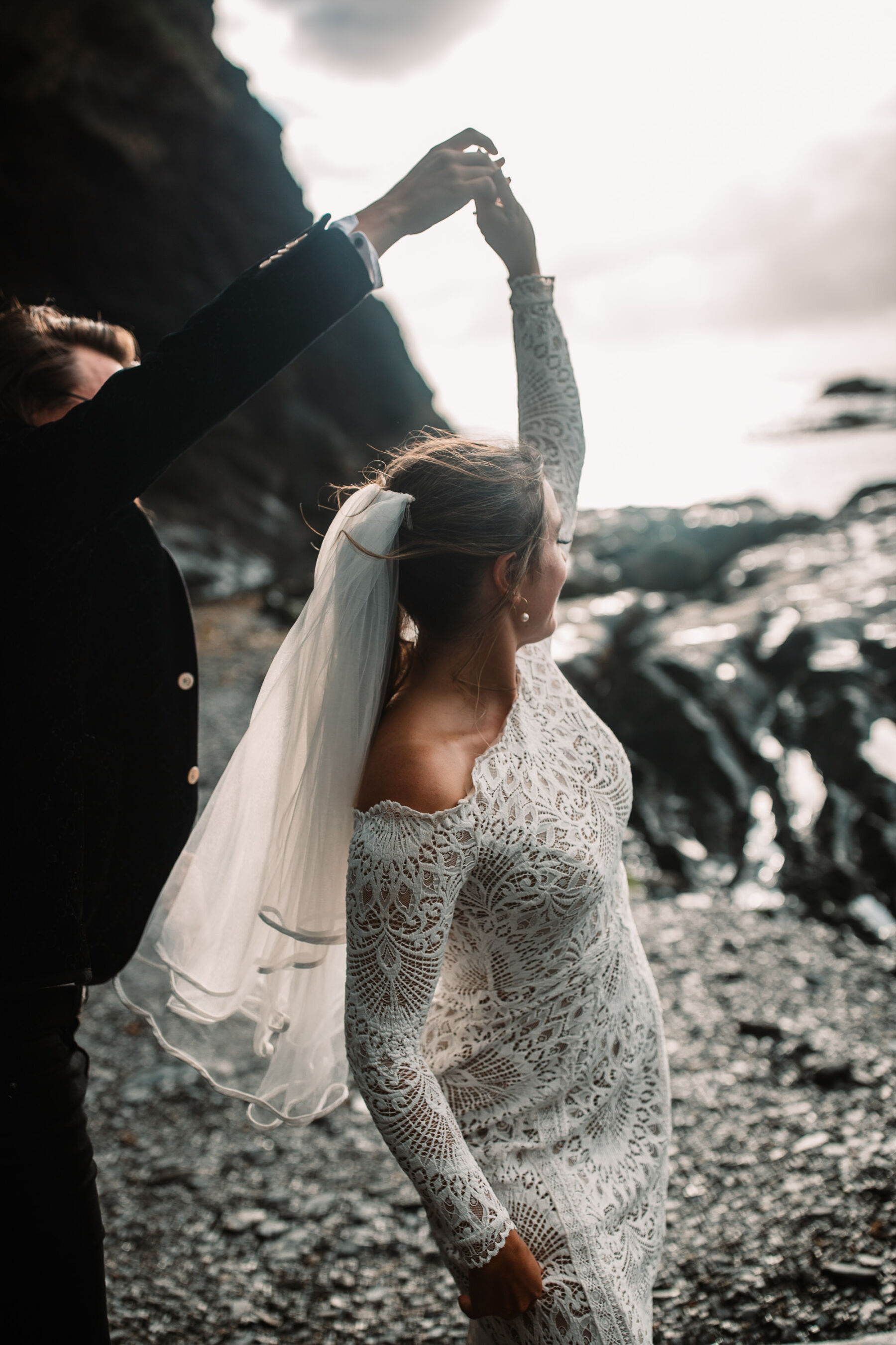 A Devon Wedding with a Sea View for Georgie in Grace Loves Lace 47 Bride and groom dancing on the beach t Tunnels Beaches wedding venue in Devon. Bride wears Grace Loves Lace.