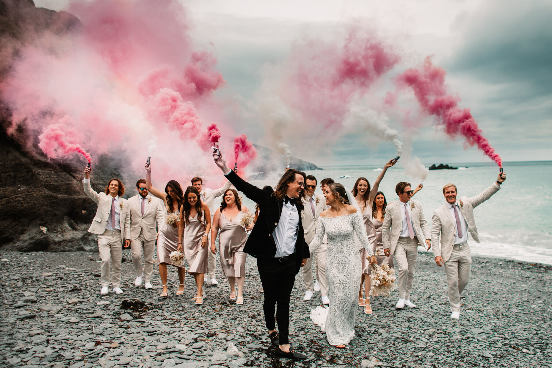 Pink wedding smoke bombs at Tunnels Beaches wedding venue, Devon