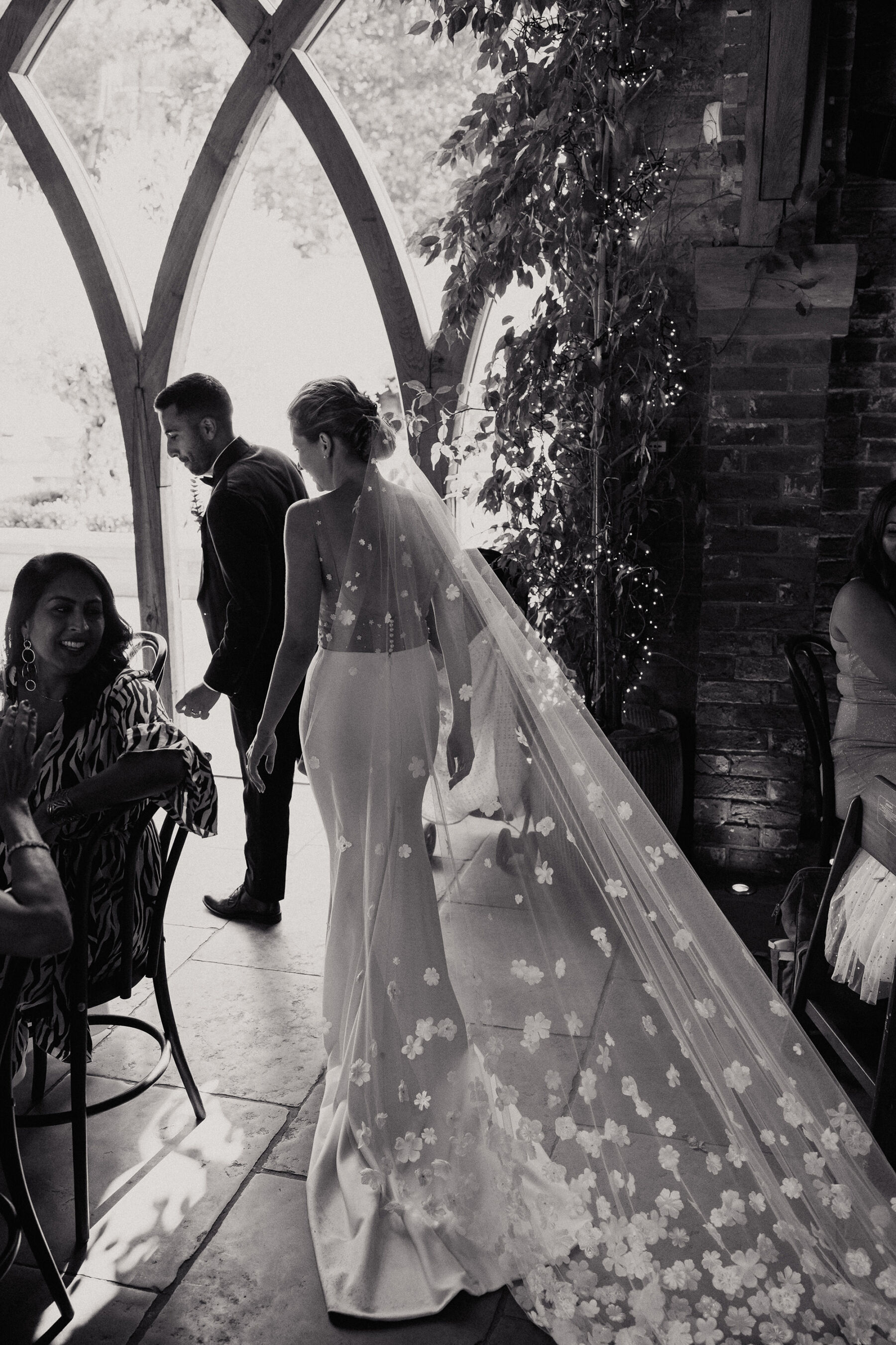 Long wedding veil covered in cut-out silk fabric flowers. Shustoke Barn wedding venue.