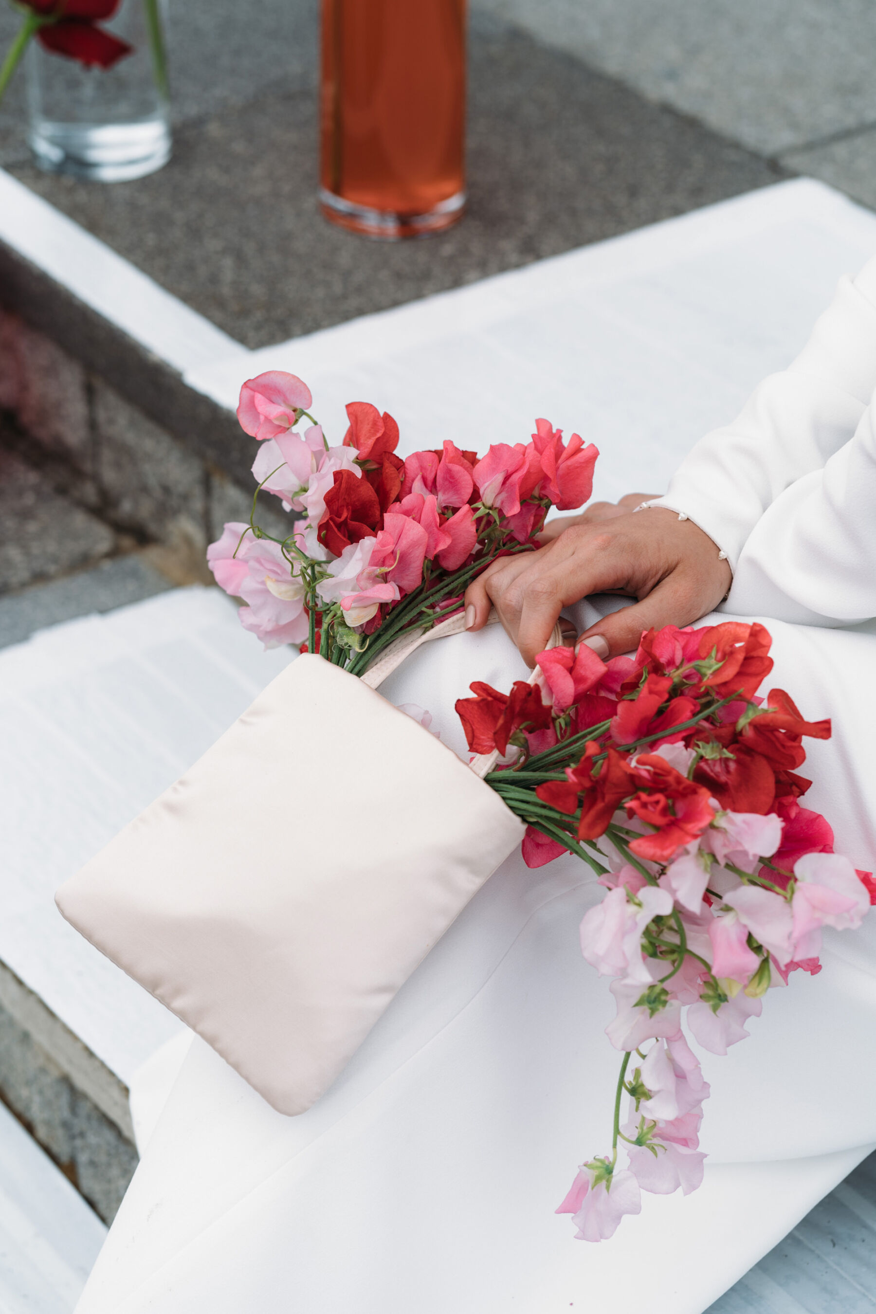 Cute bridal clutch bag spilling with sweet pea flowers. Joanna Bongard Photography.