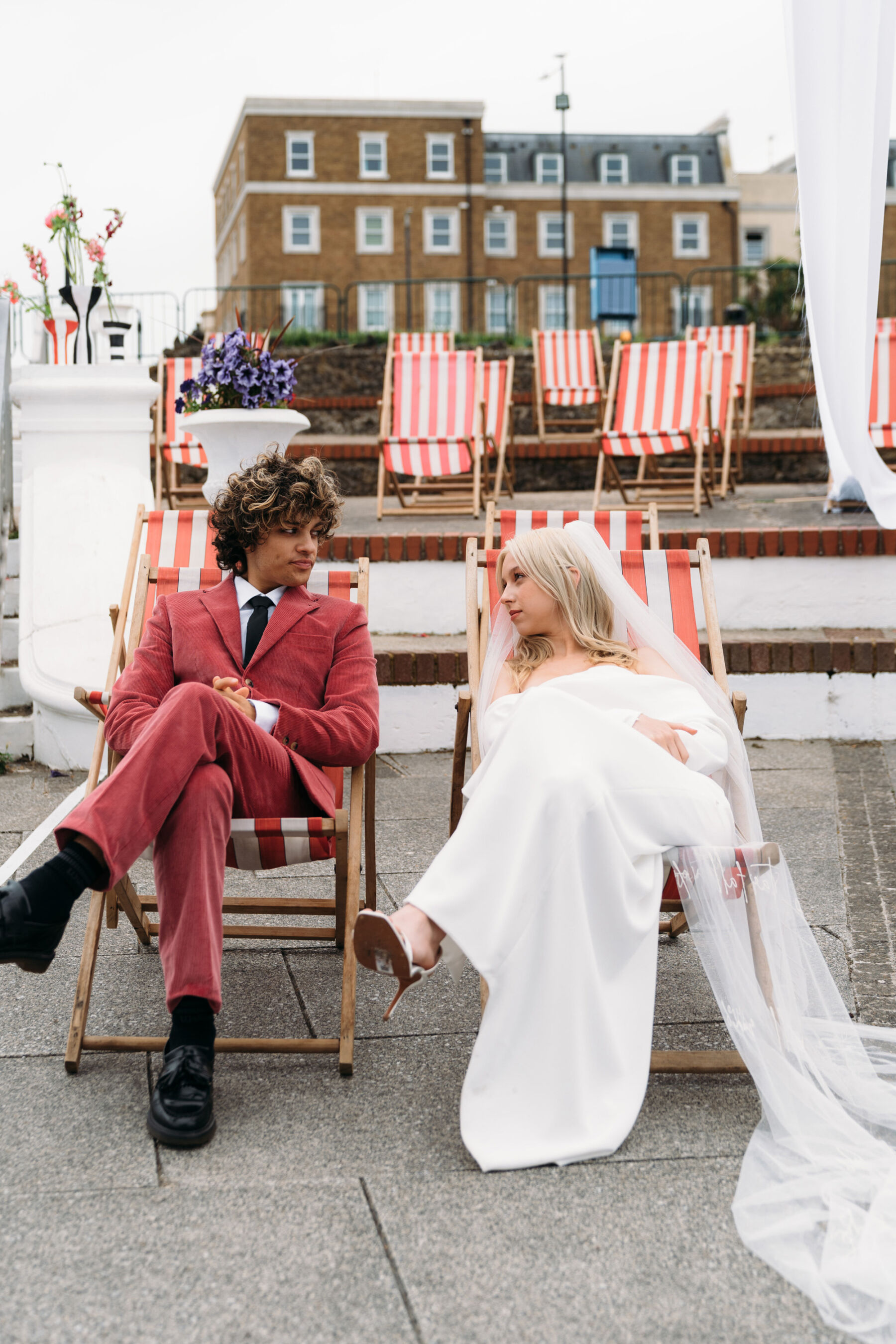 Bride and groom sat on deck chairs. Joanna Bongard Photography.