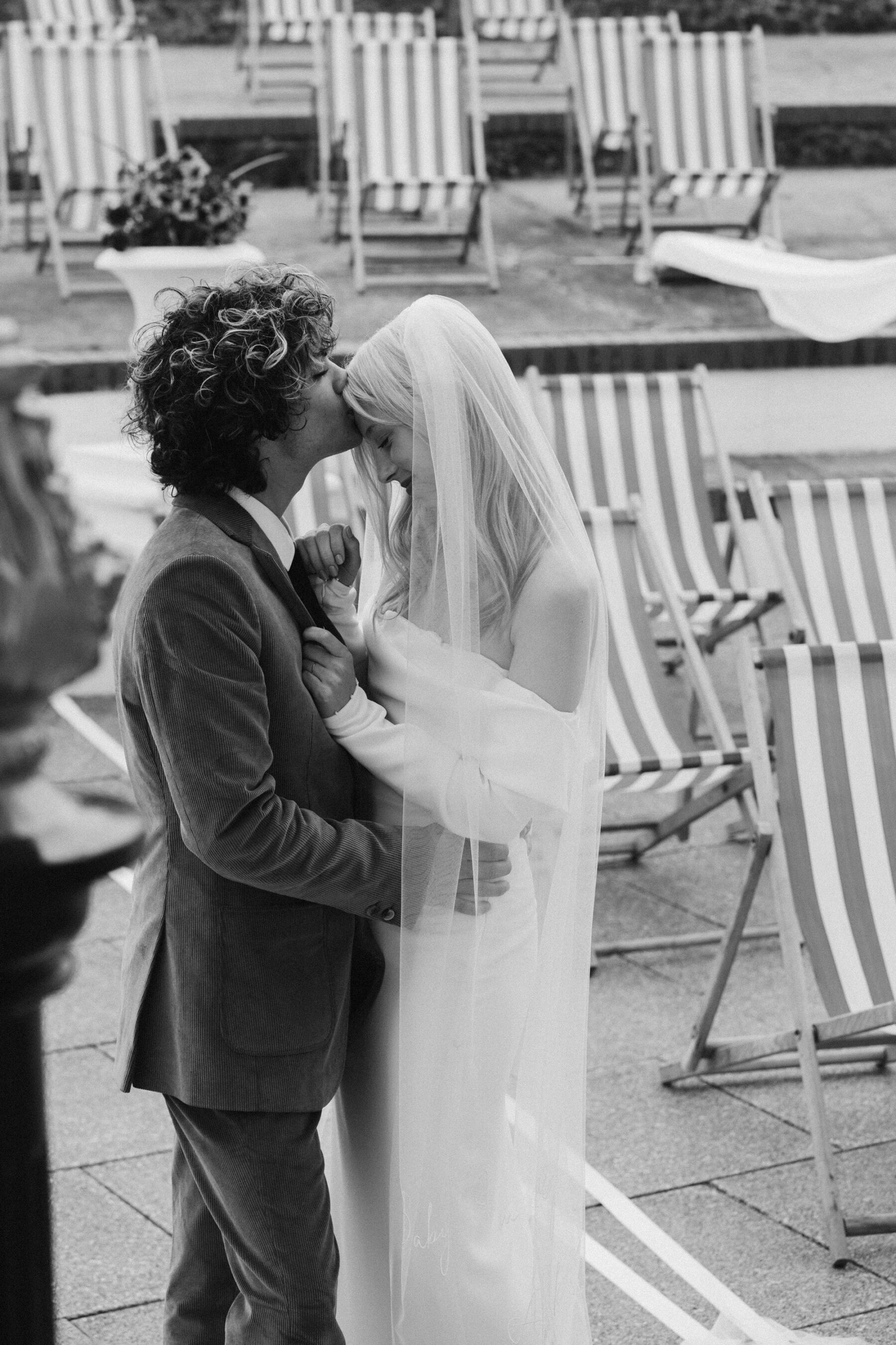 Groom embracing bride in Bon Bride wedding dress. Joanna Bongard Photography.