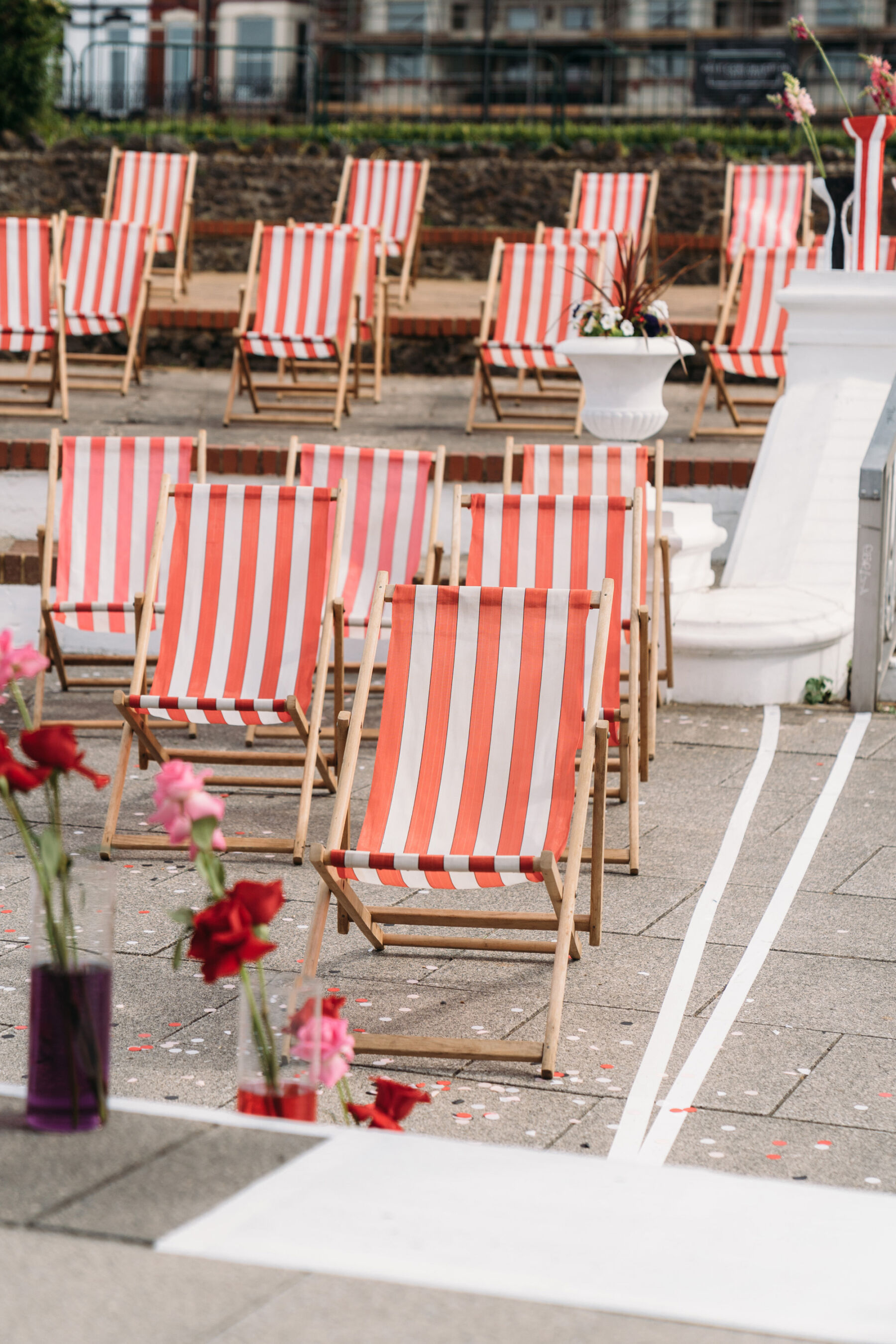 Traditional stripy deckchairs as wedding ceremony seating. Joanna Bongard Photography.