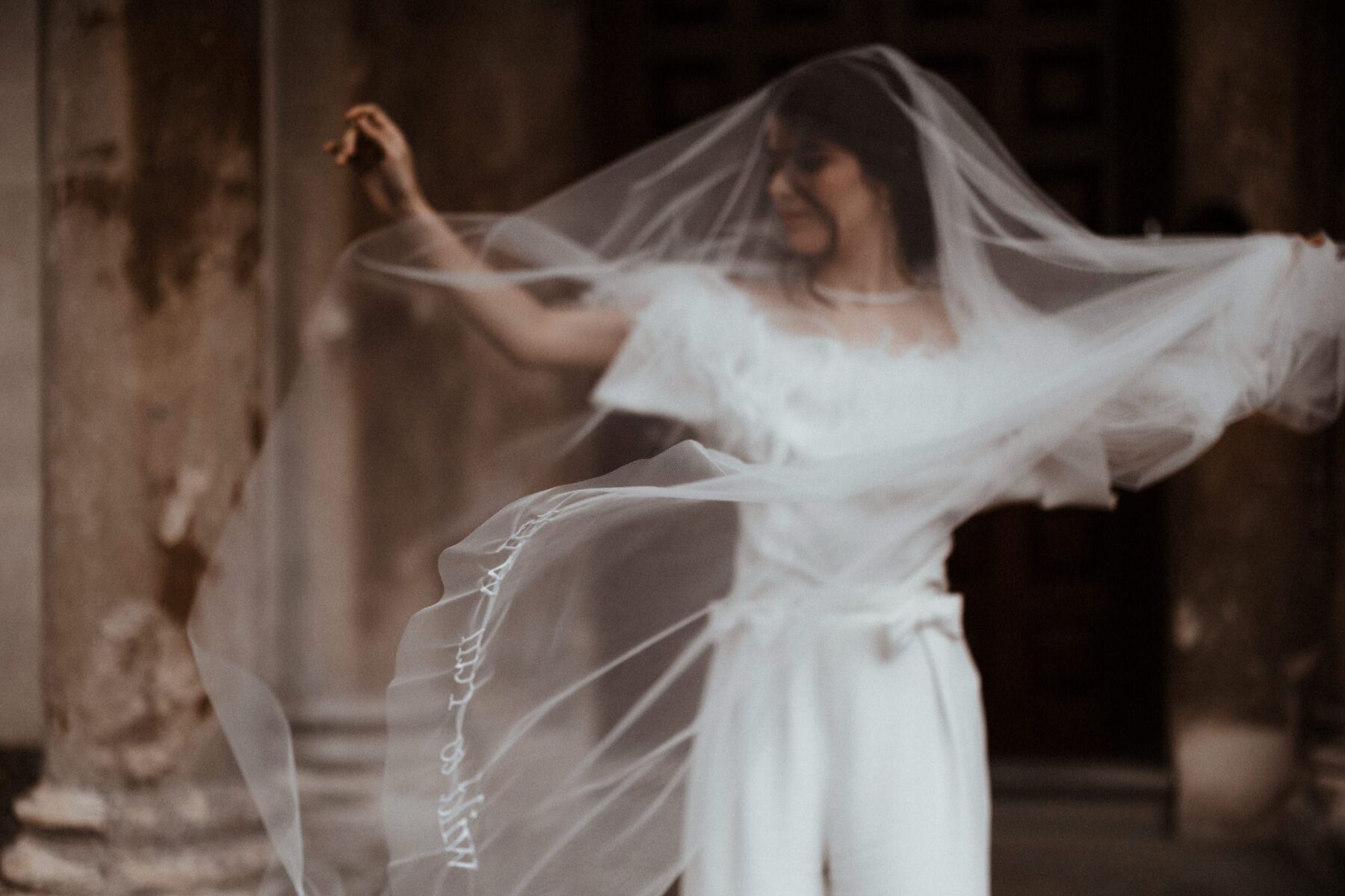 Bride with a fly away embroidered wedding veil.