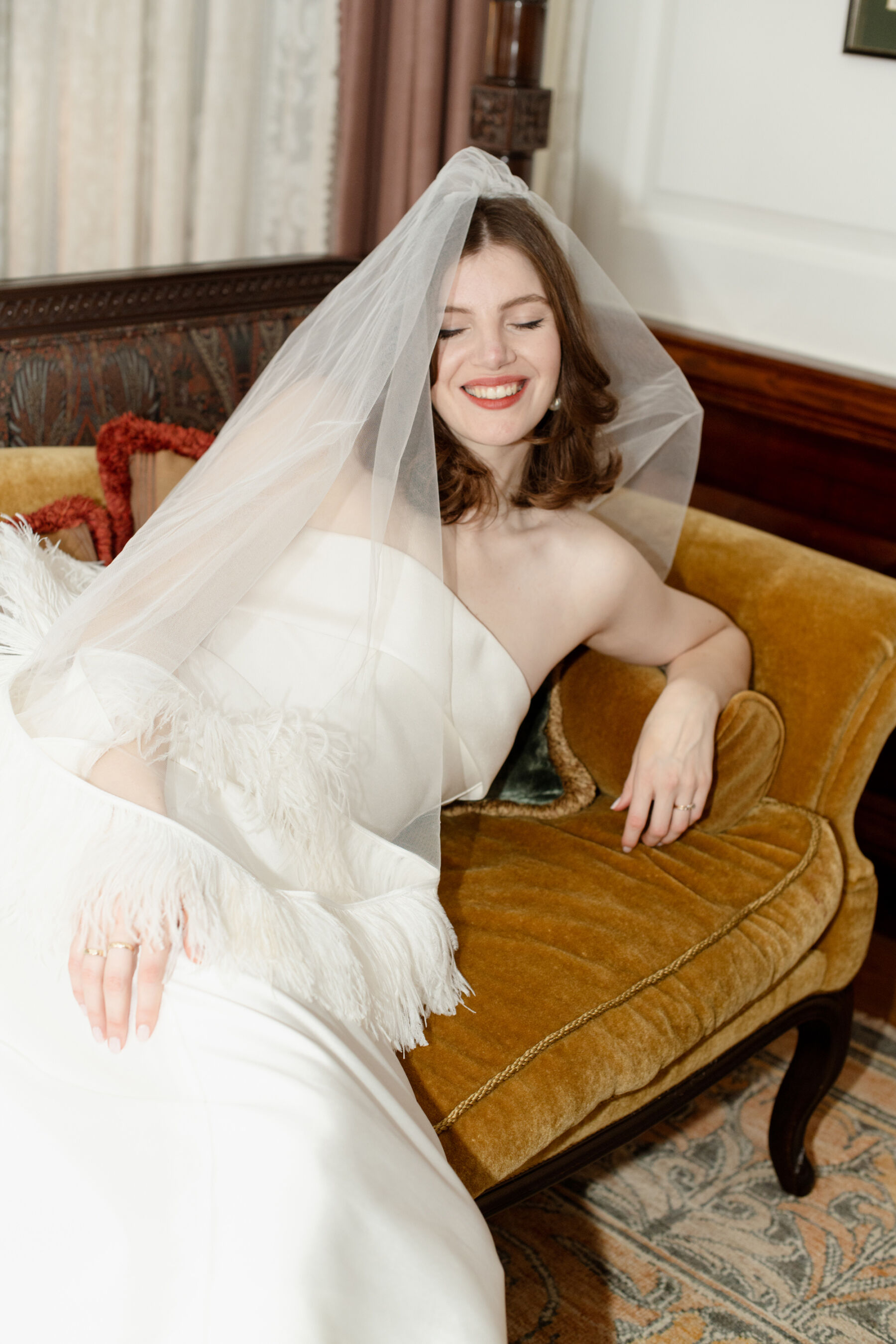 Stylish modern bride wearing a feather veil by Christopher Kane.