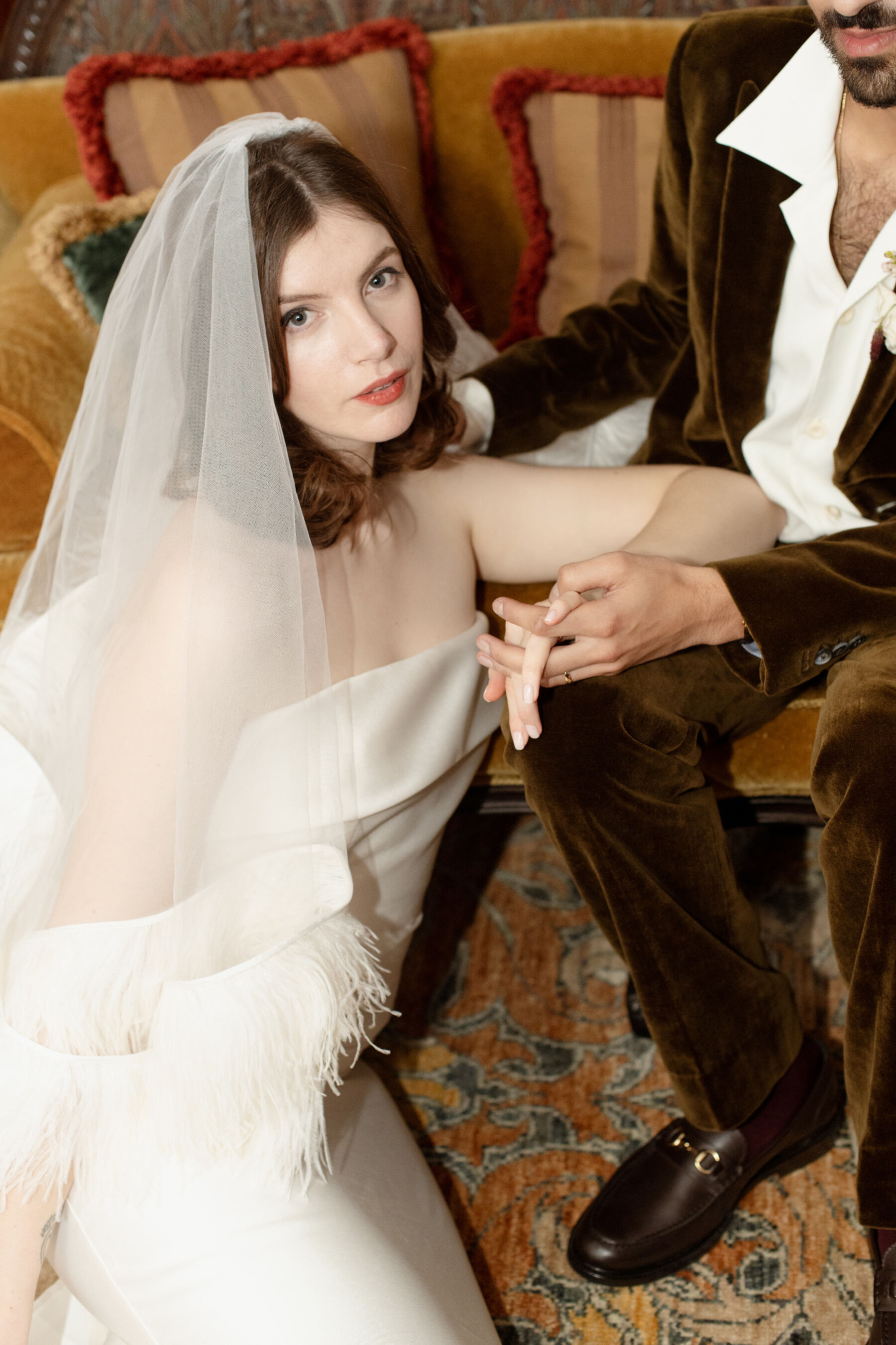 Stylish modern bride wearing a feather veil by Christopher Kane.