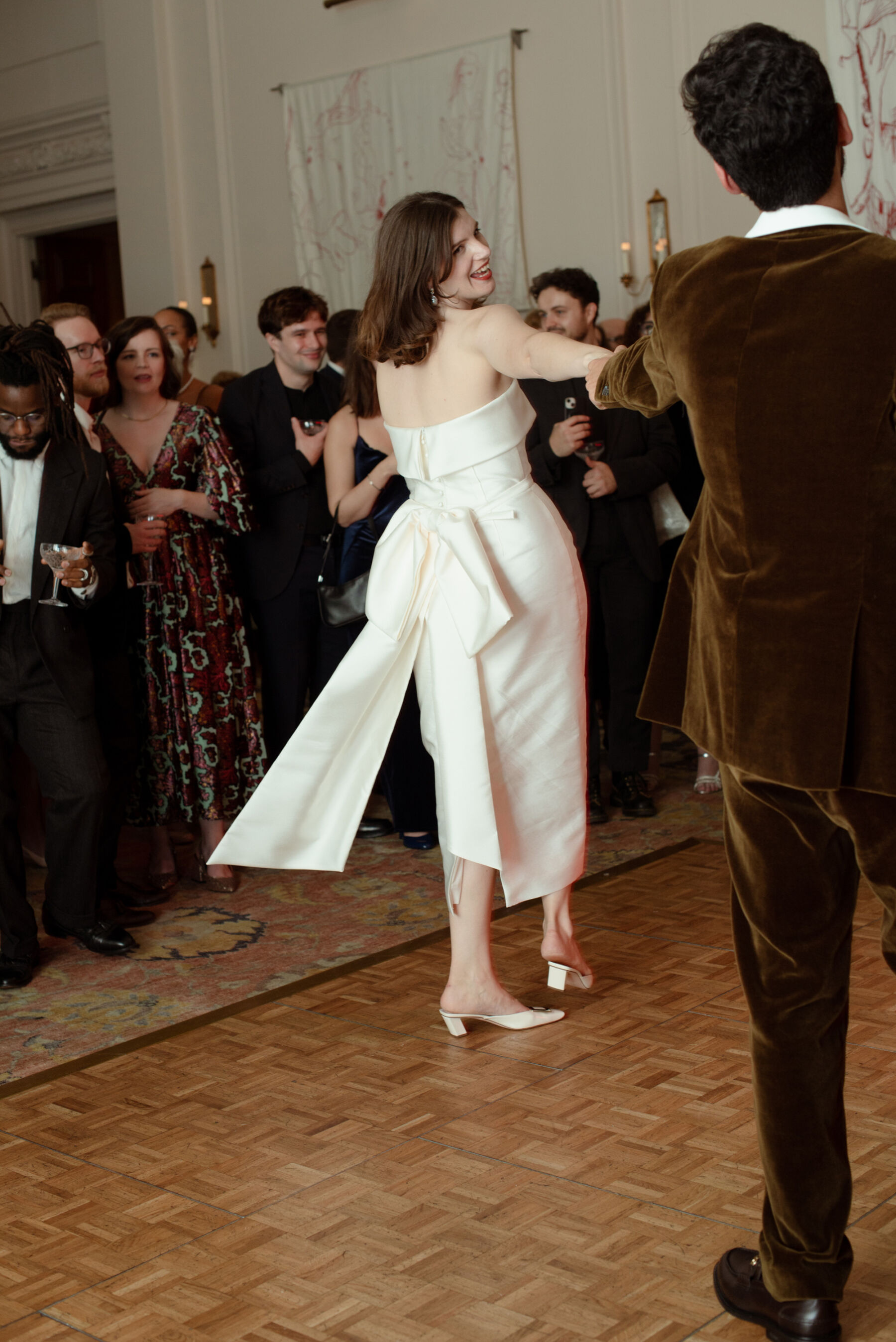 Bride dancing in a Jessica Bennett dress with bustle bow.