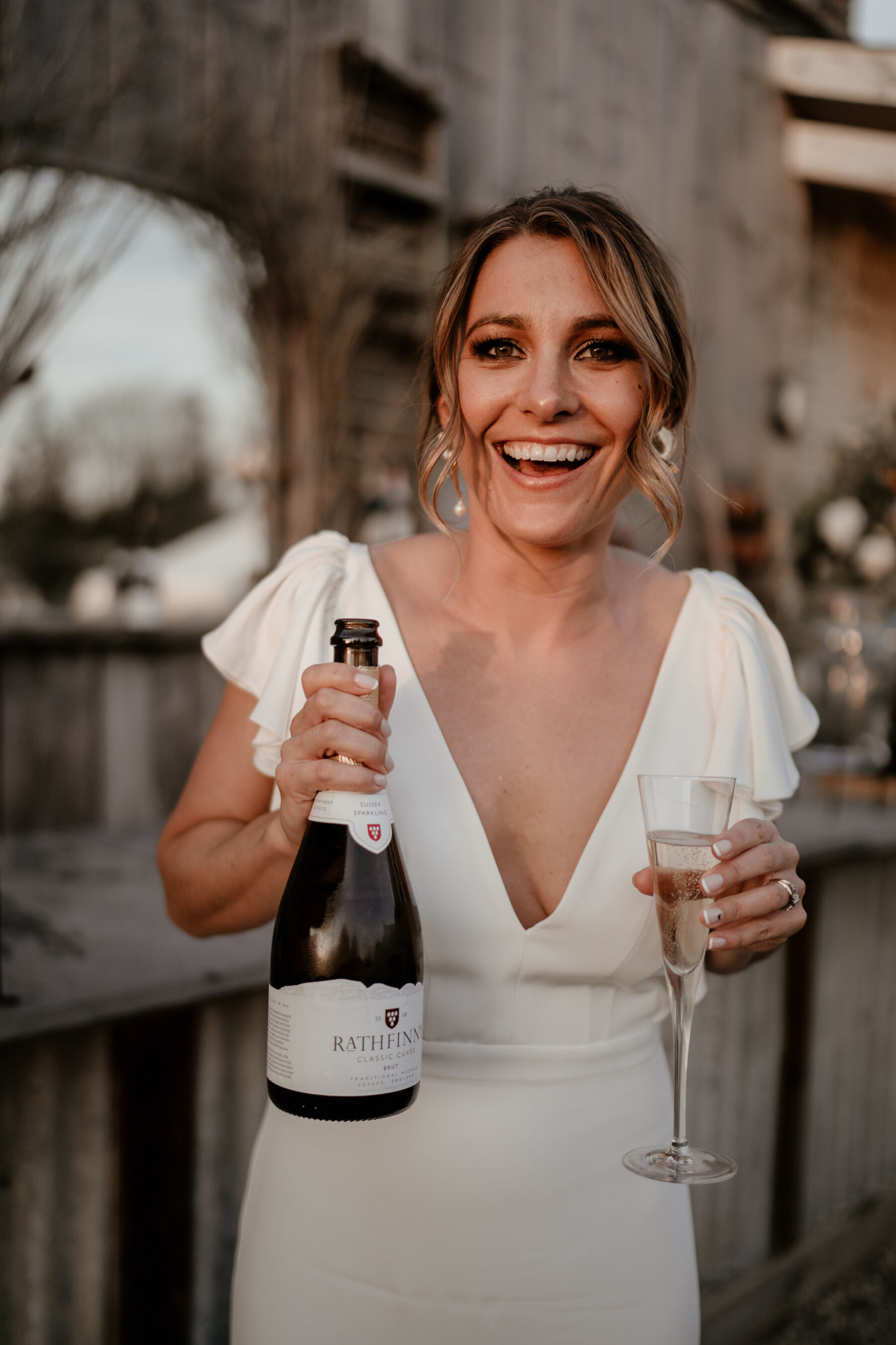 Bride holding a bottle of champagne