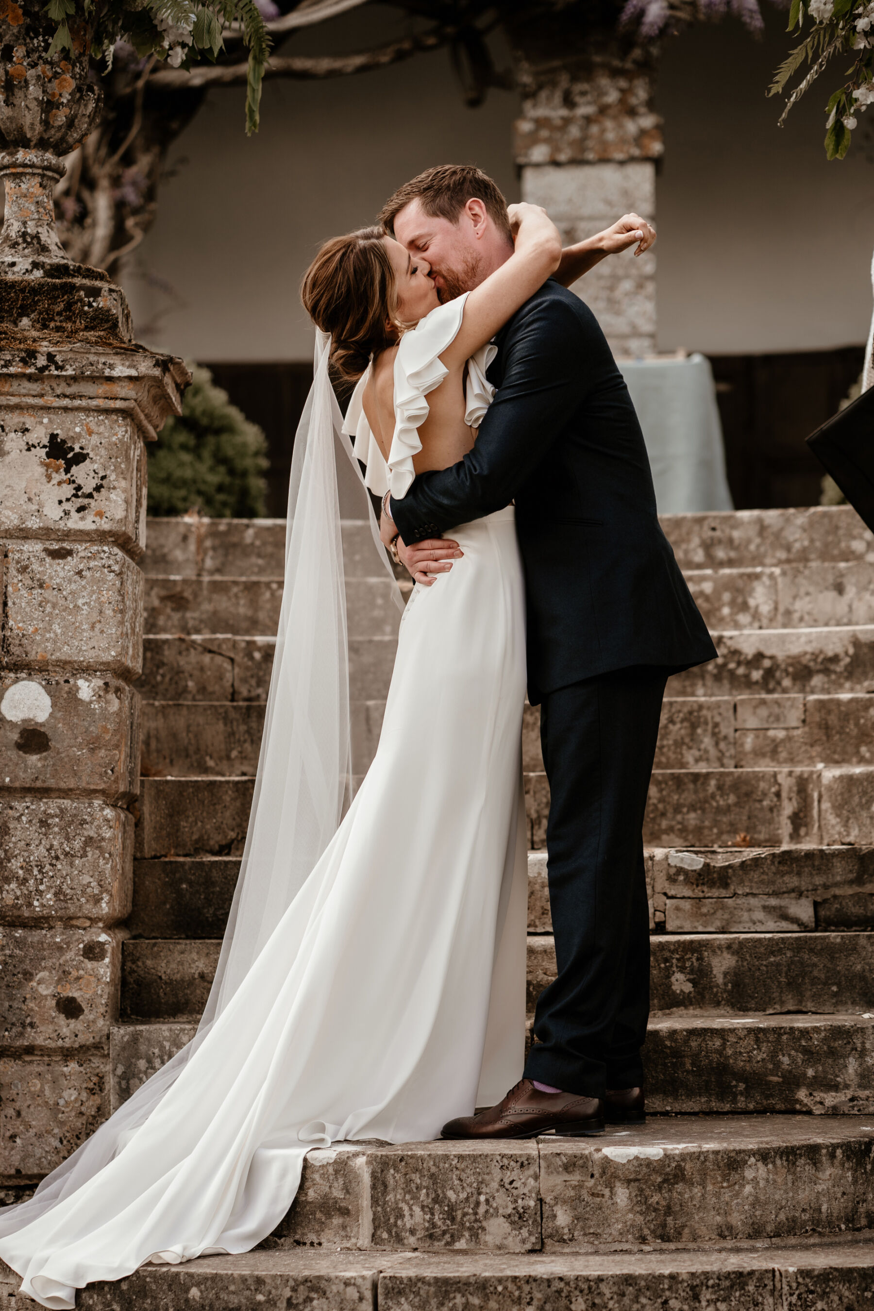 Bride and groom embracing at Hatch House wedding in Wiltshire