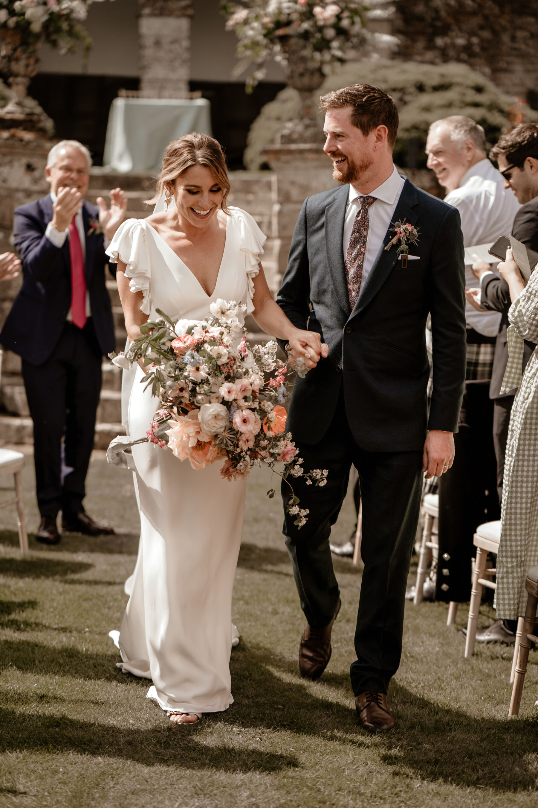 Alexandra Grecco bride carrying a beautiful oversized Spring wedding bouquet