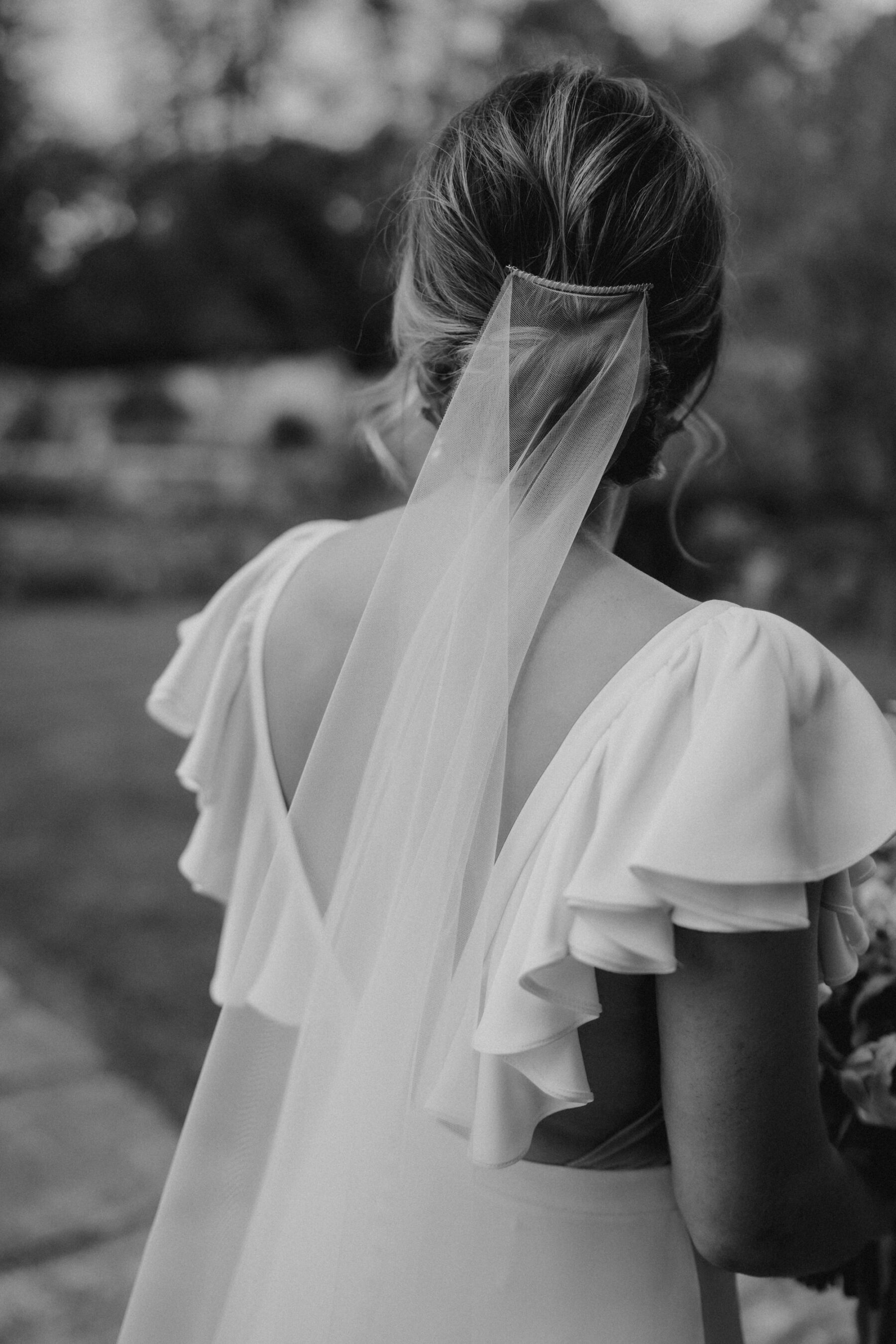 Back view of bride with an Alexander Grecco wedding dress with ruffled sleeves