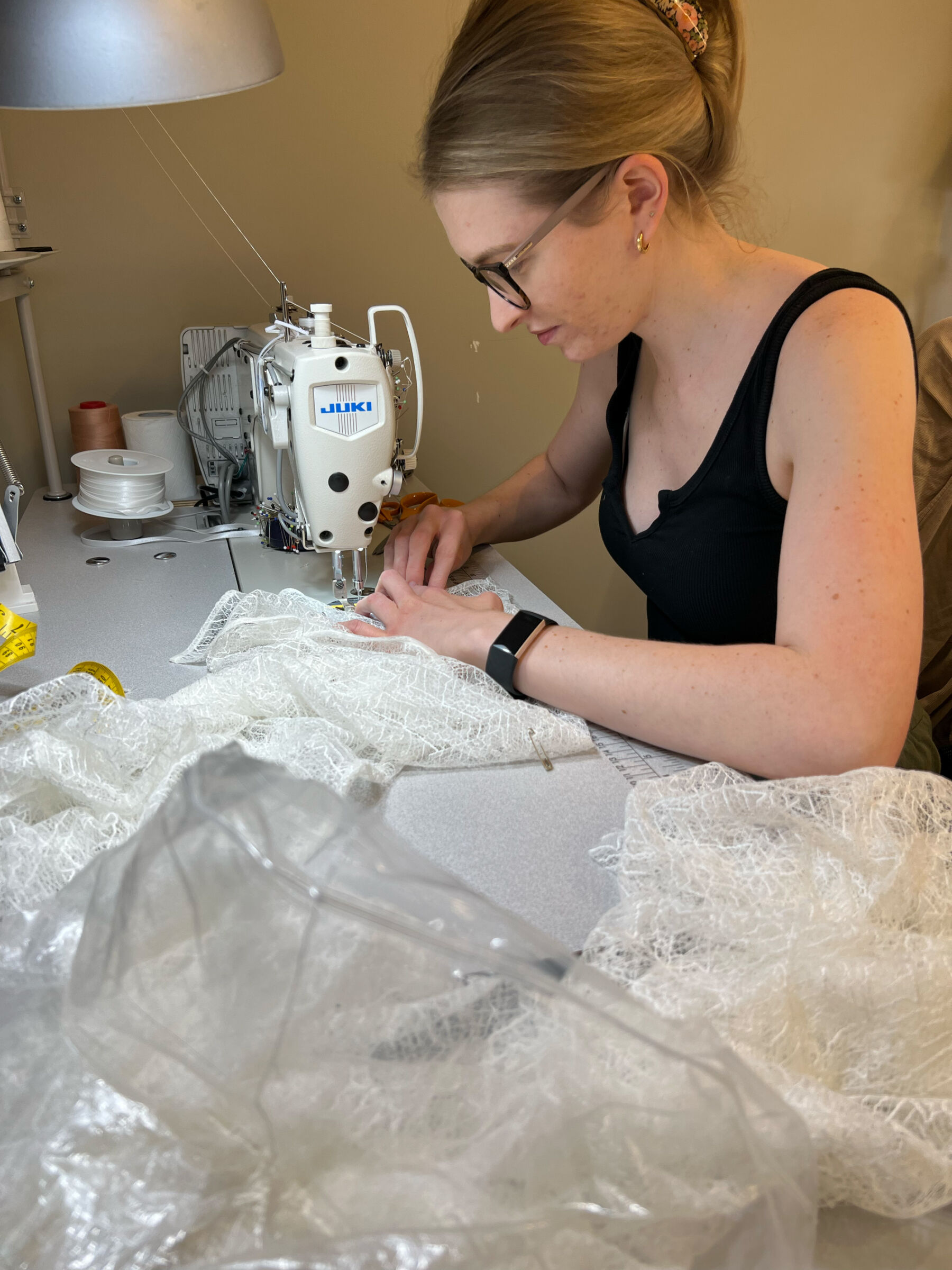 Seamstress creating a wedding dress at Andrea Hawkes Bridal