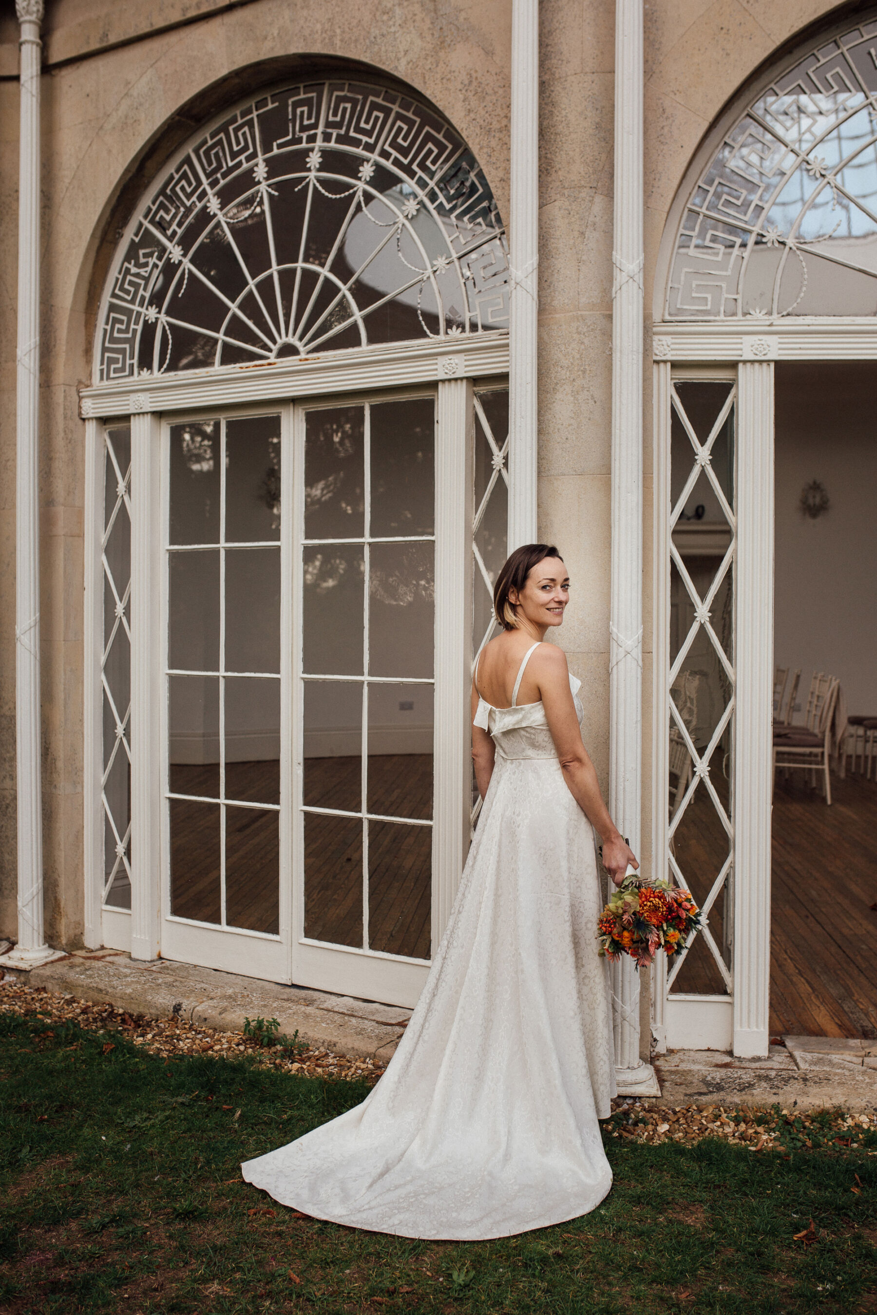 Bride standing by the Orangery at Barton Hall.