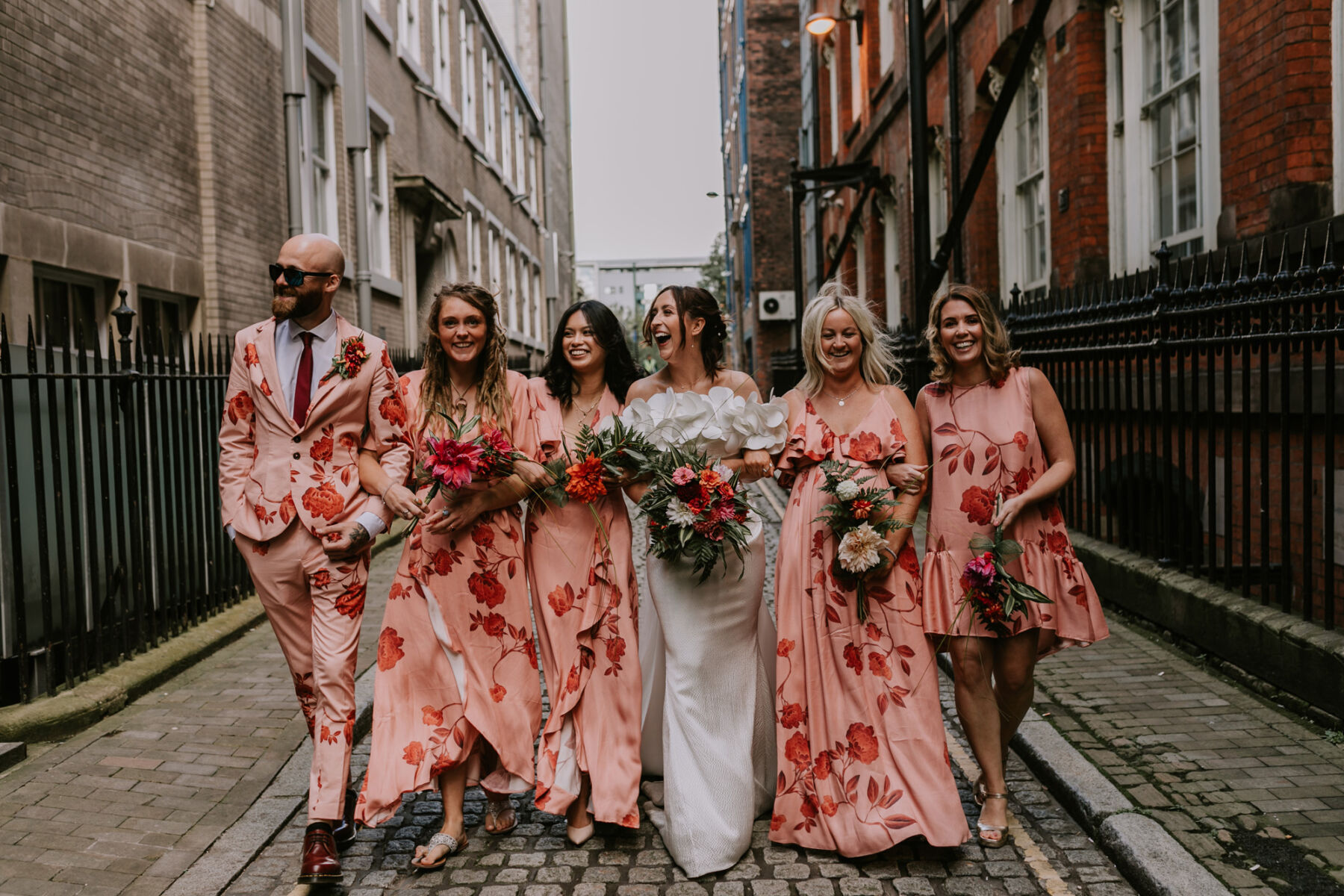 Bridesmaids in floral peach dresses