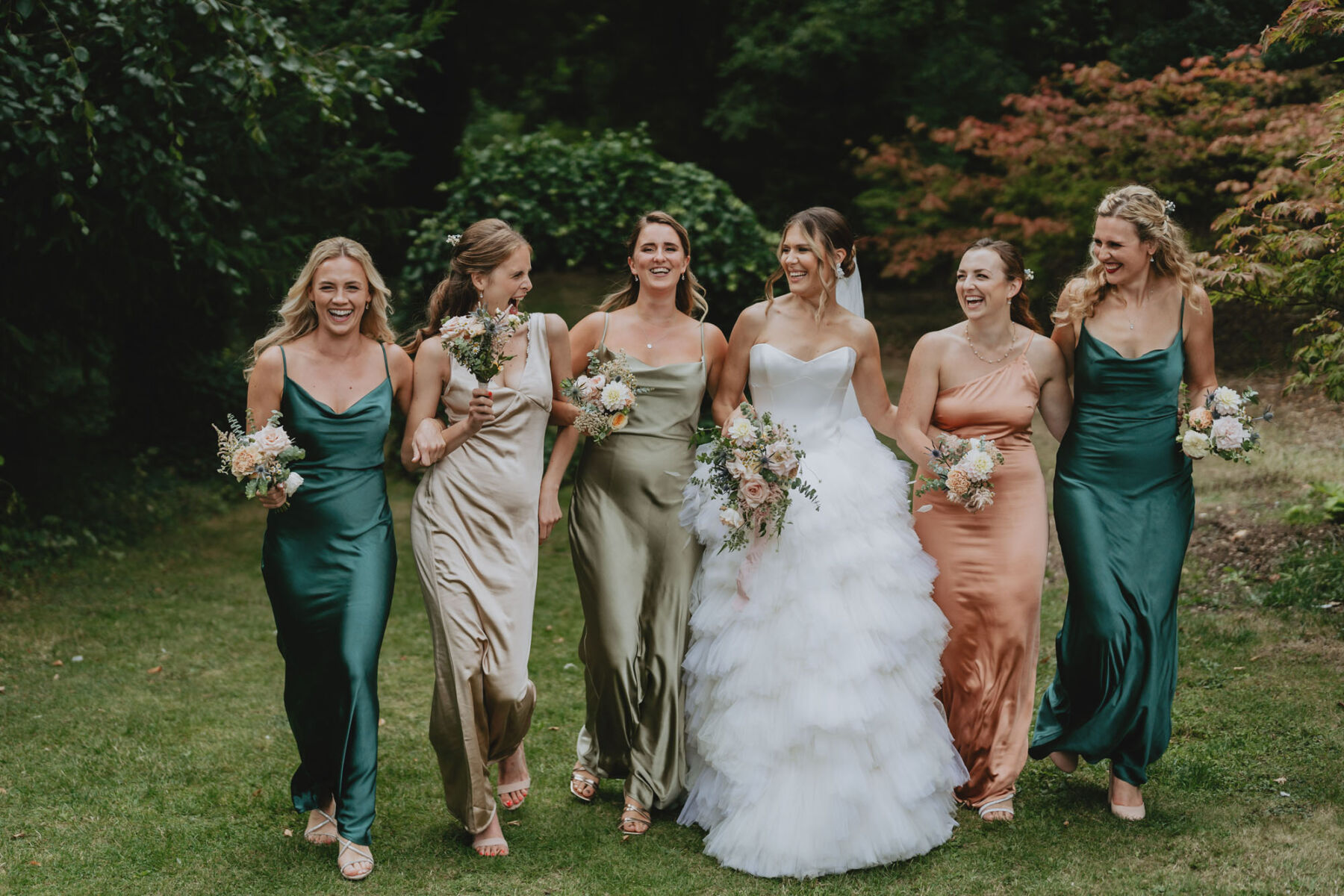 Bridesmaids in various shades of green