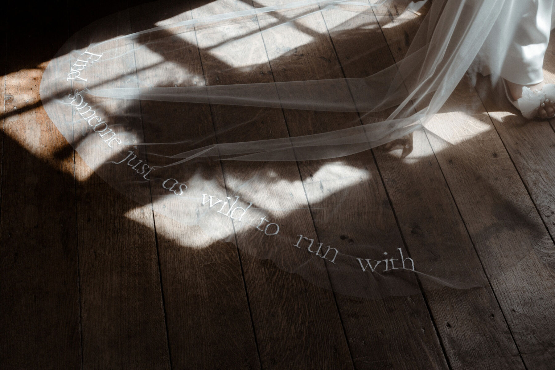Veil embroidered with the words 'Find someone just as wild to run with'. By Rebecca Anne Designs.