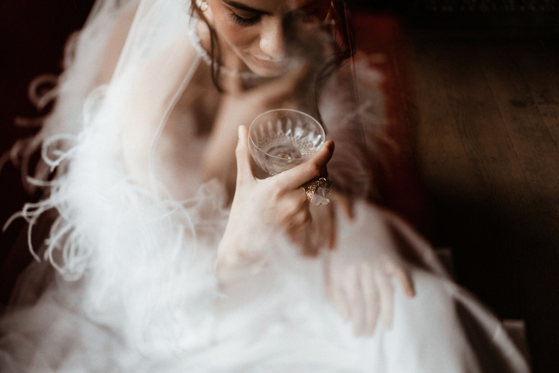 Quiet Moments of Bridal Fashion With Wilden London & Rebecca Anne Designs 12 Bride looking romantically into a crystal cut champagne glass.