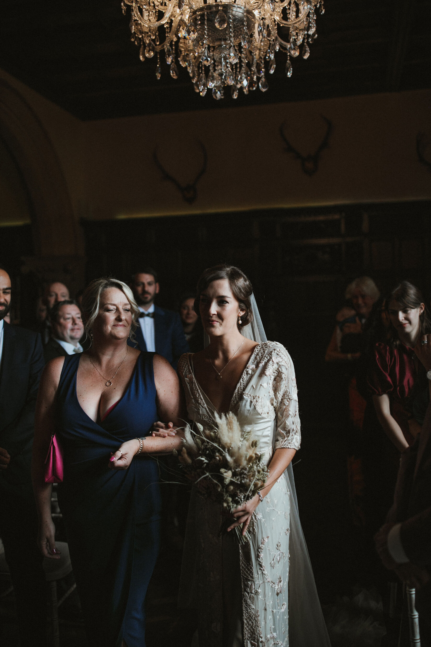 Bride walking down the aisle with her mum, wears a Jane Bourvis vintage wedding dres.