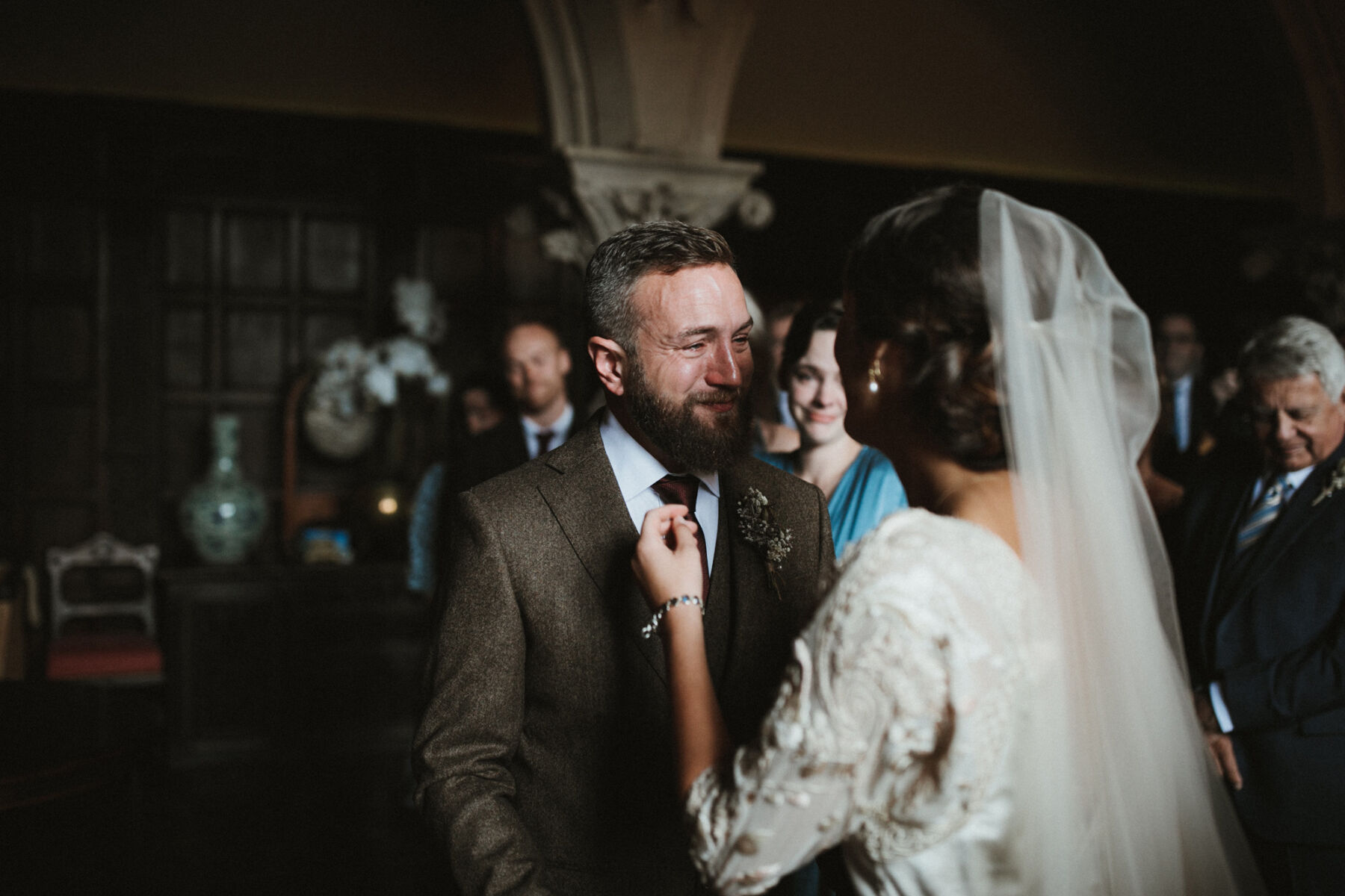 Emotional groom greets his bride at the altar.