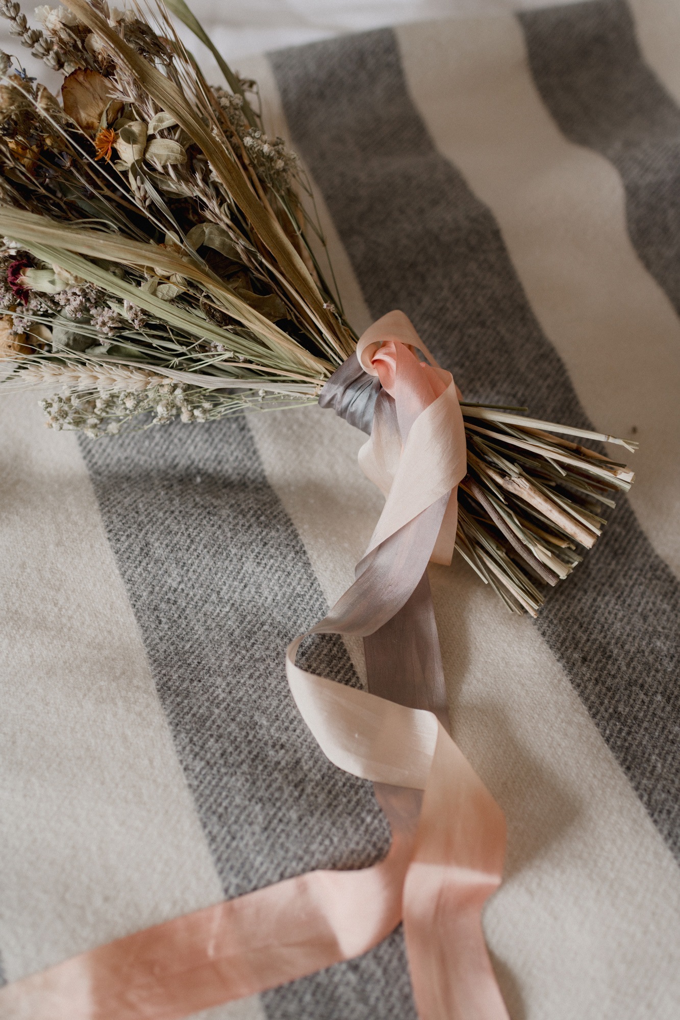 A Laidback Wedding in Cornwall With Dried Flower Bouquets 9 Silk ombre ribbons tied around a dried flower wedding bouquet.