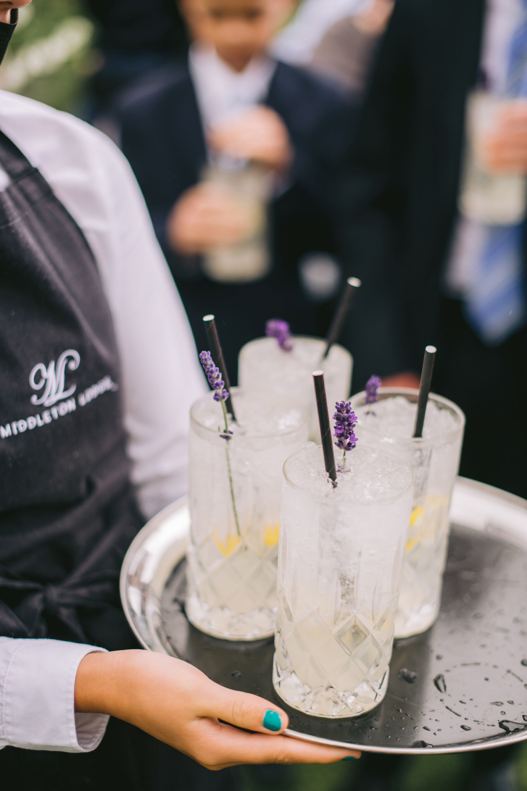 Frances and Ben's Classy, Classic English Summer Wedding at Middleton Lodge 18 Tall glasses of fizz at a wedding on a tray held by a waitress.