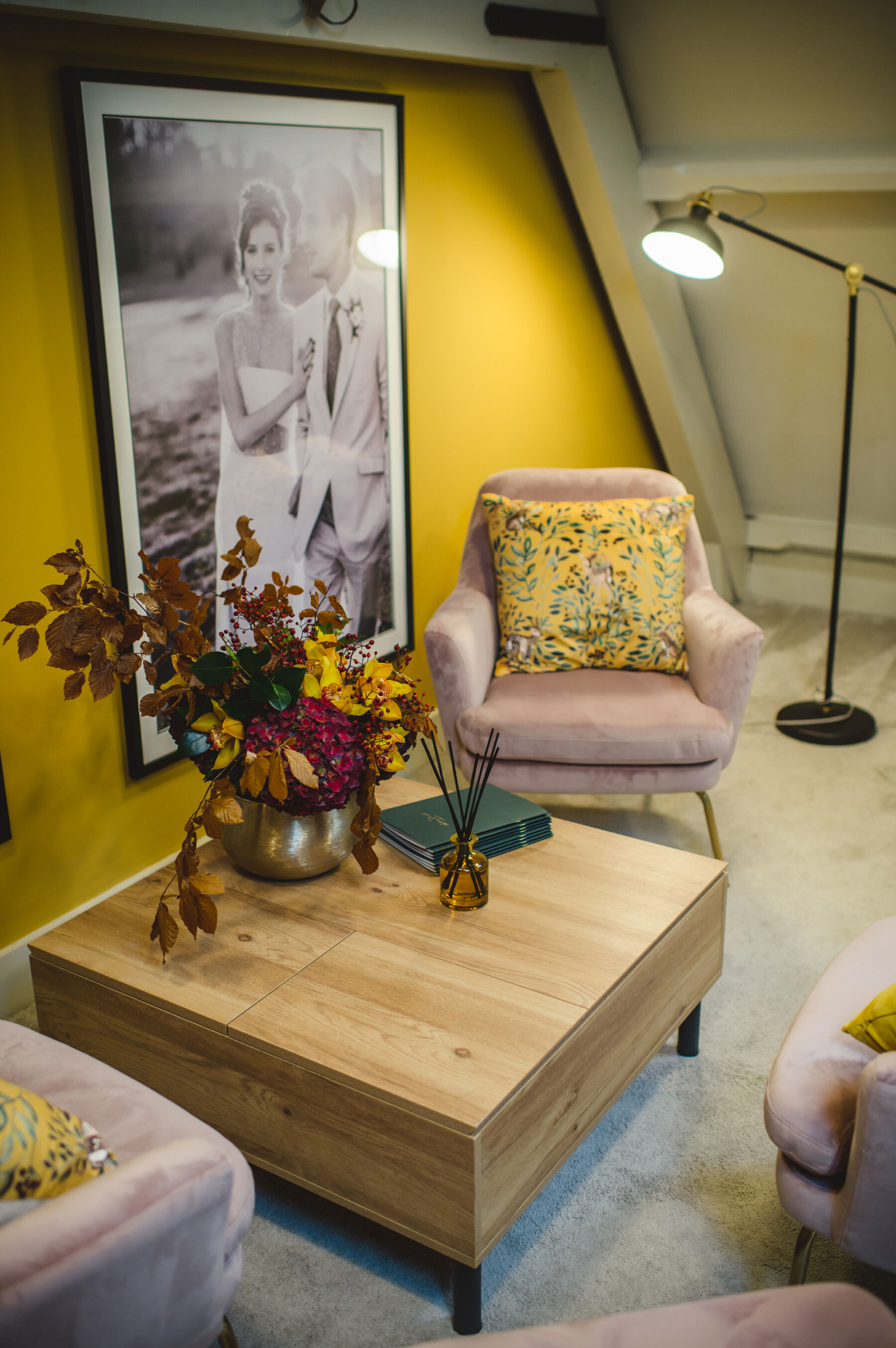 Bridal consultation area inside the Miss Bush bridal boutique, Ripley, Surrey. Pink velvet chair, yellow walls.