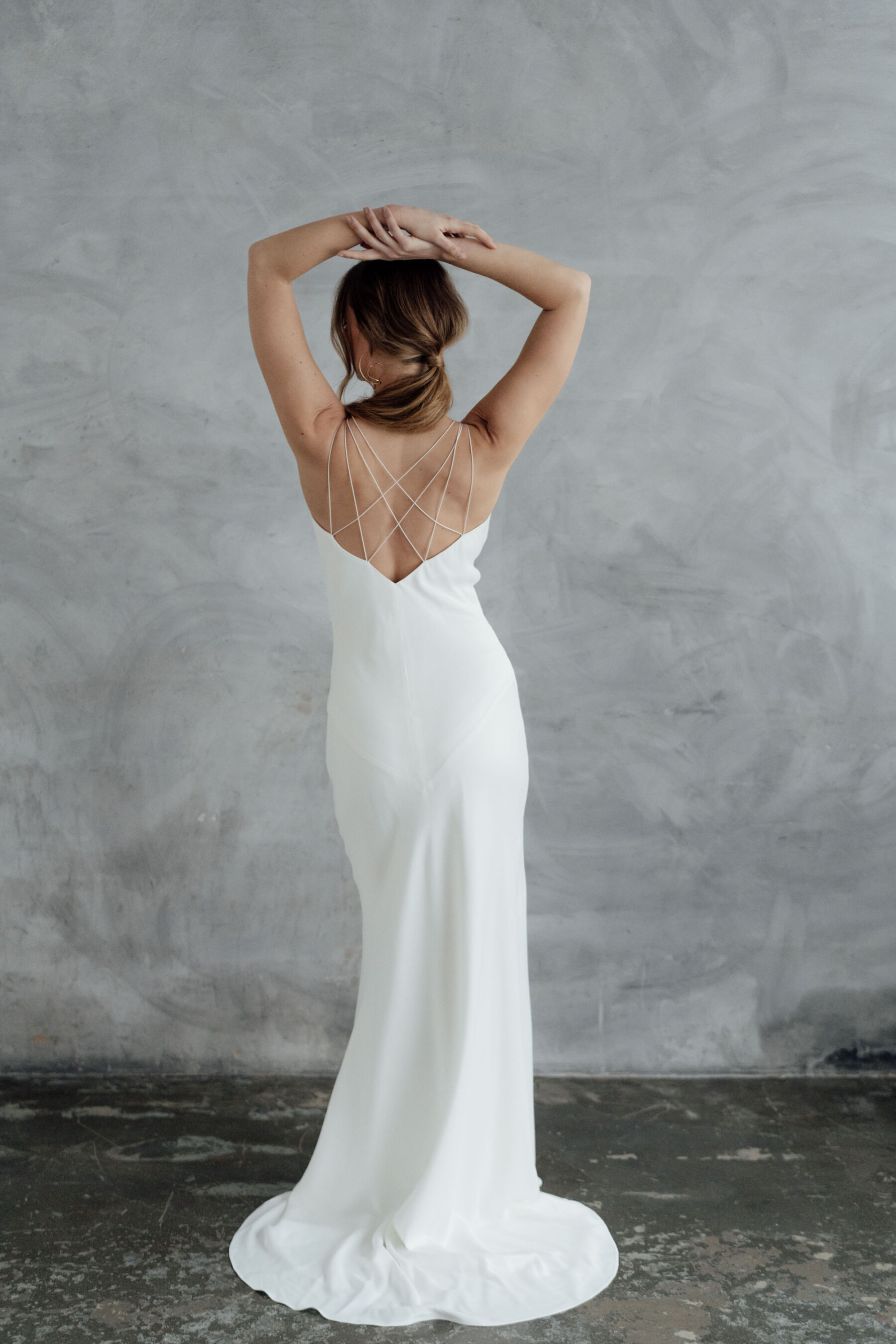Bridal gown slip dress with cross over spaghetti straps at the back.