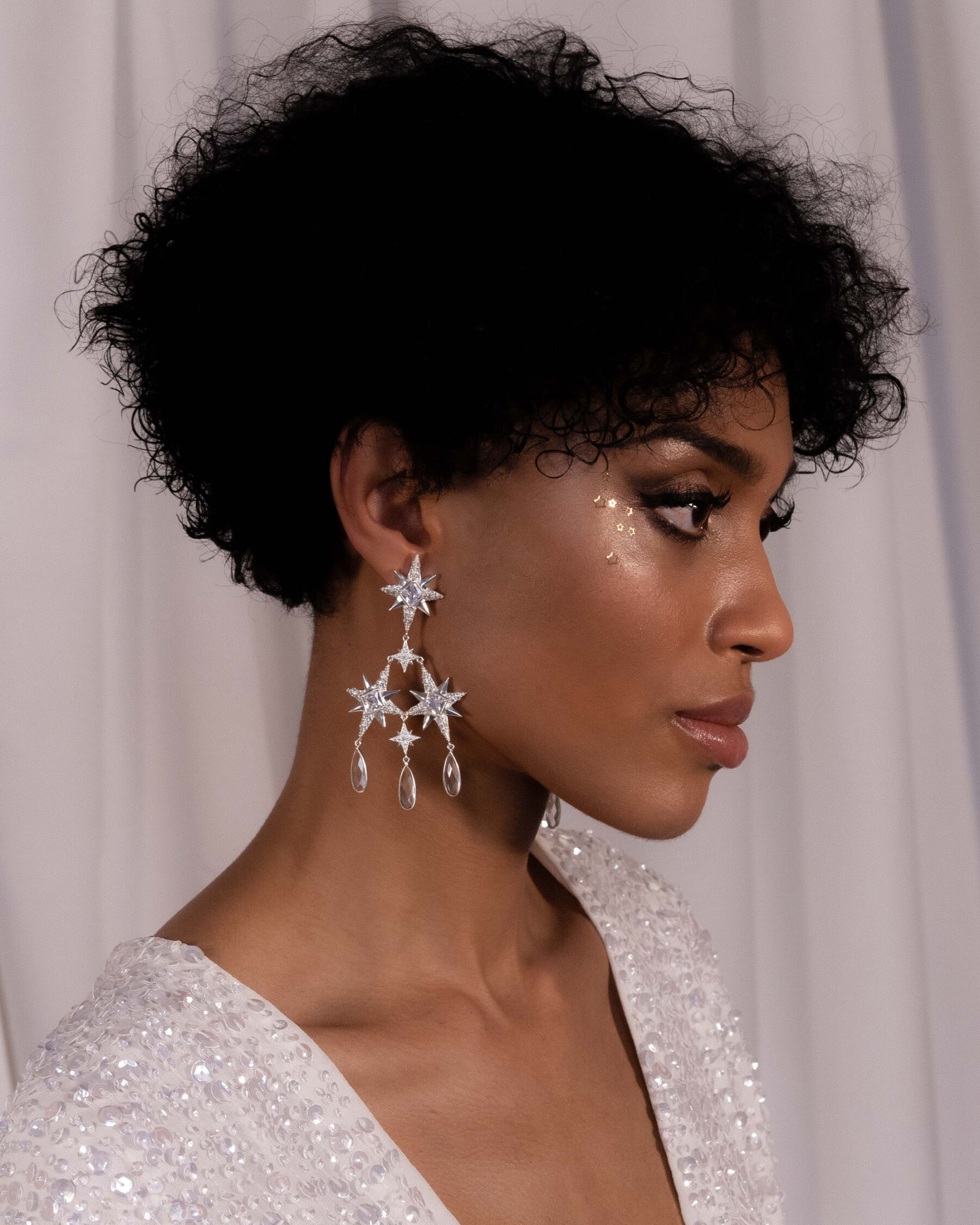 Victoria Percival - black model wearing statement starry and celestial earrings. 