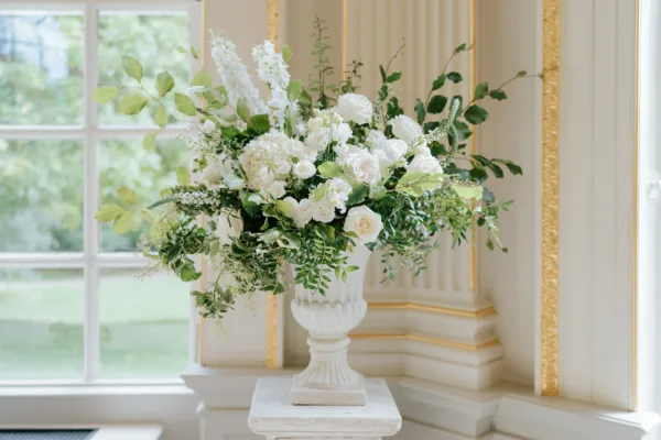 A beautiful garden urn full of green and white flowers. Ready for the wedding ceremony at Orleans House Gallery