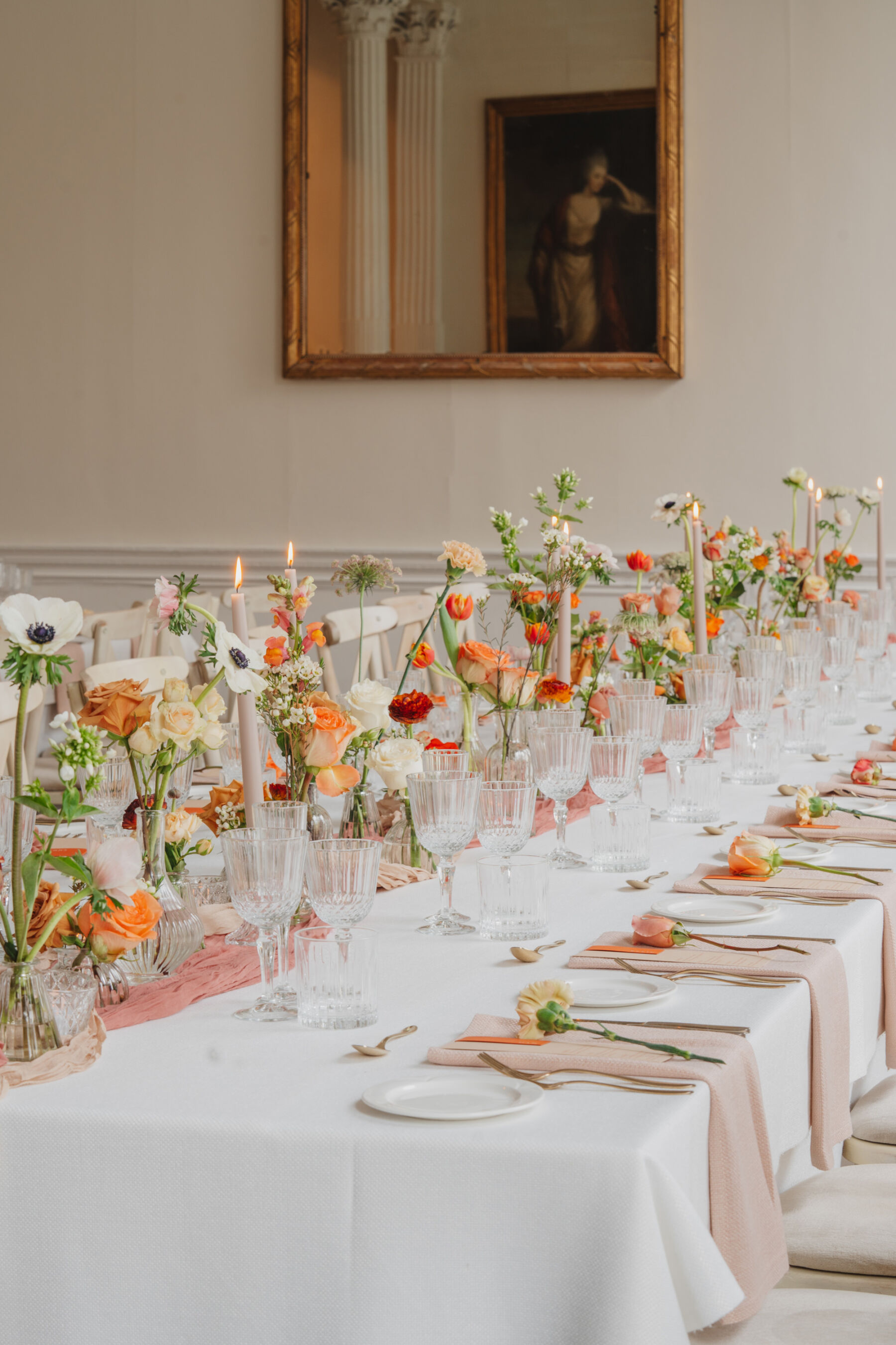 How to Create a Beautiful Sustainable Wedding on a Small Budget, with 41 Portland Place, London 4 Wedding reception table decorated with orange and cream wedding flowers. Light, bright and airy room at 41 Portland Place London.