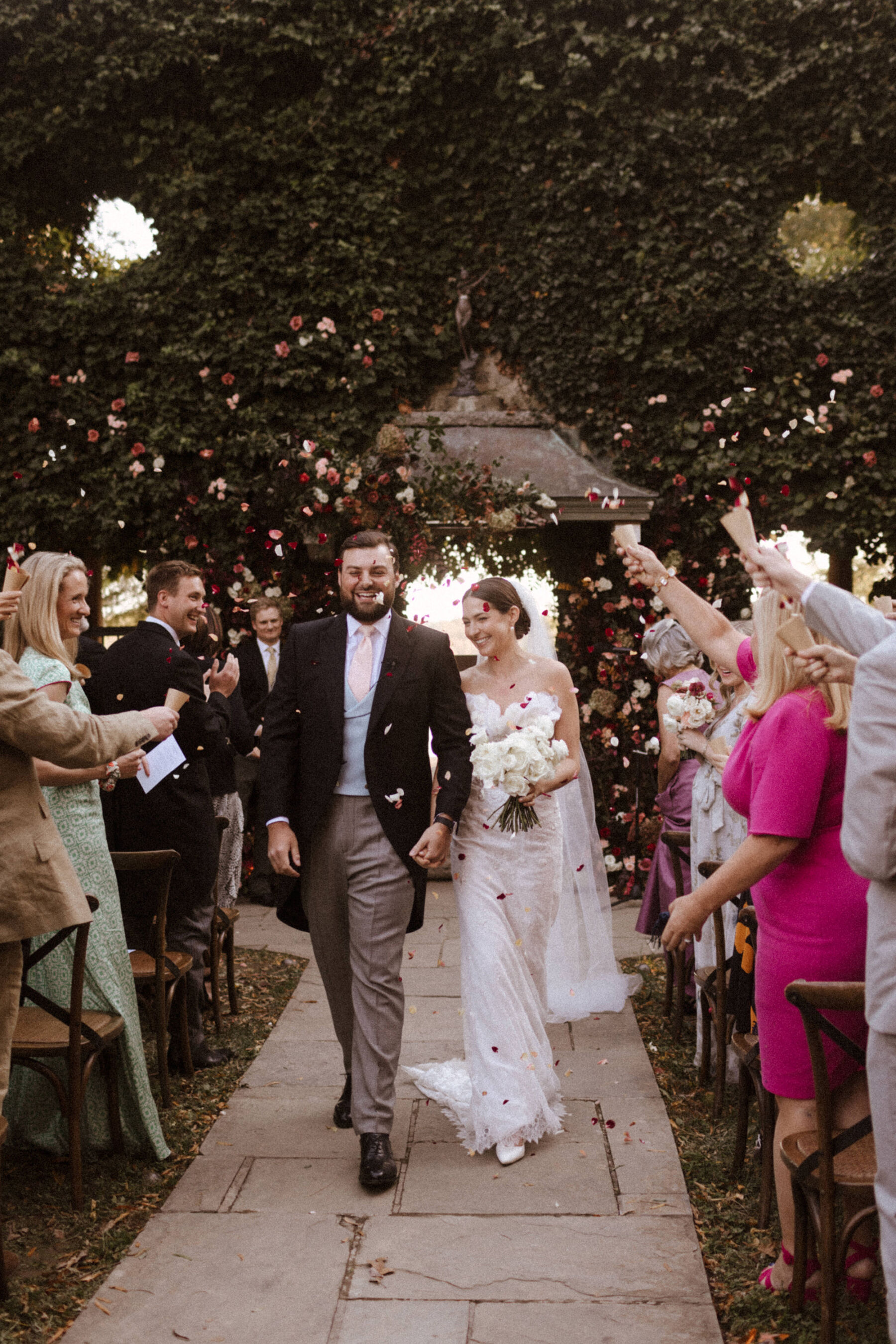 Newlywed bride and groom being showered with confetti at Goldstonn Inn Virginia USA.