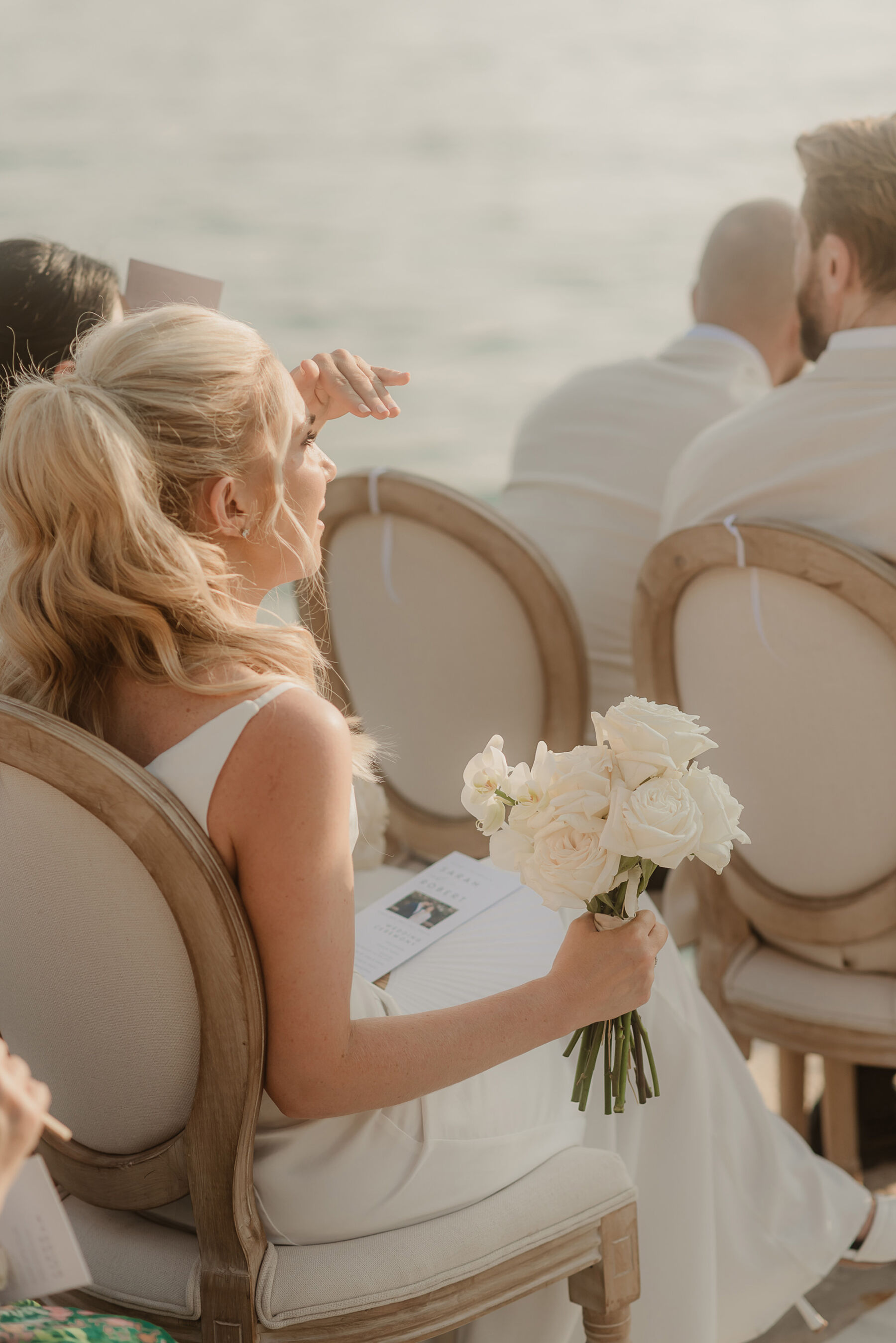 Sarah in Eva Lendel for her Classy & Contemporary Wedding in Croatia 28 Wedding guest at outdoor wedding ceremony by the sea