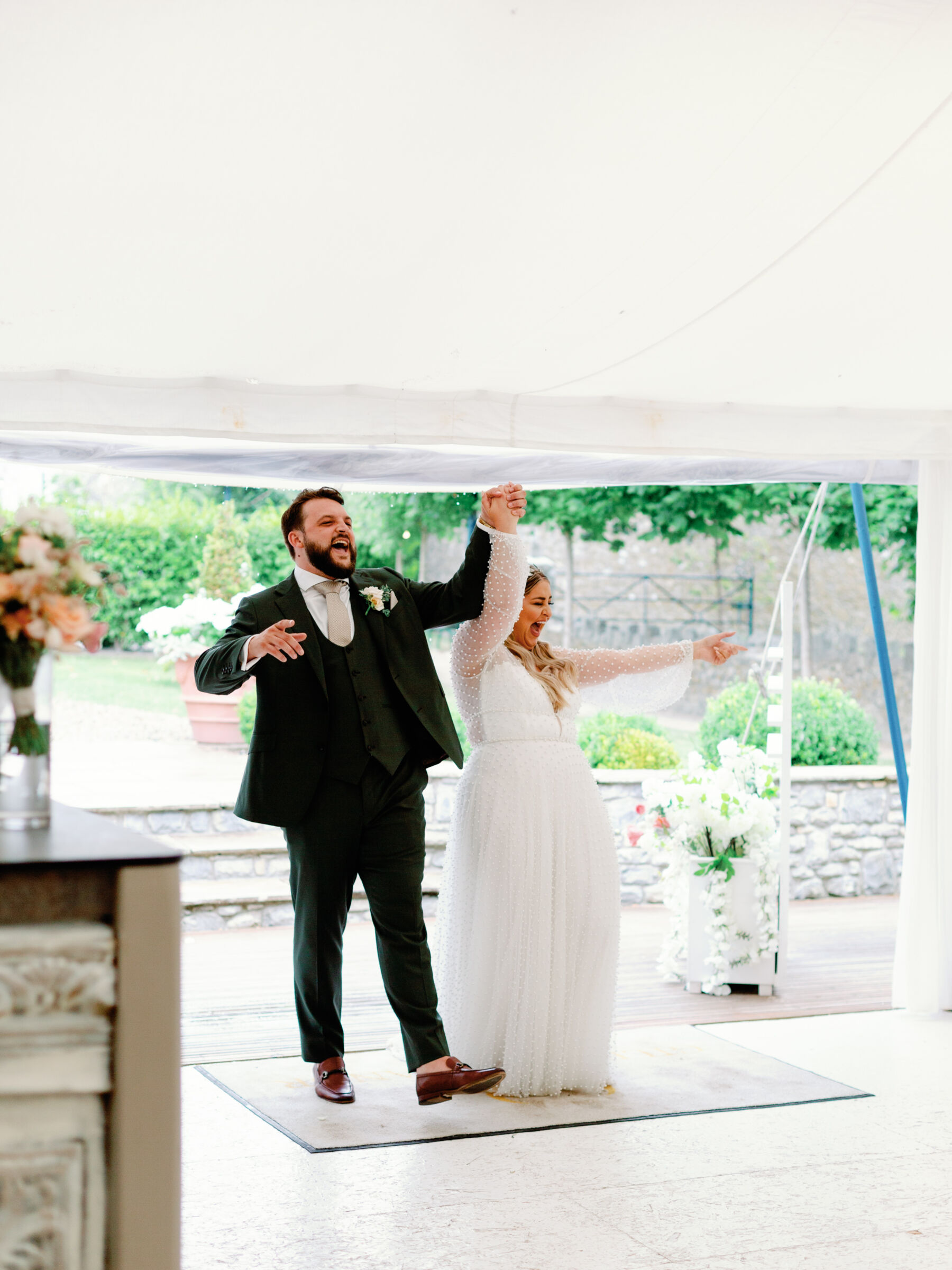 Bride and groom entering their wedding marquee to a round of applause