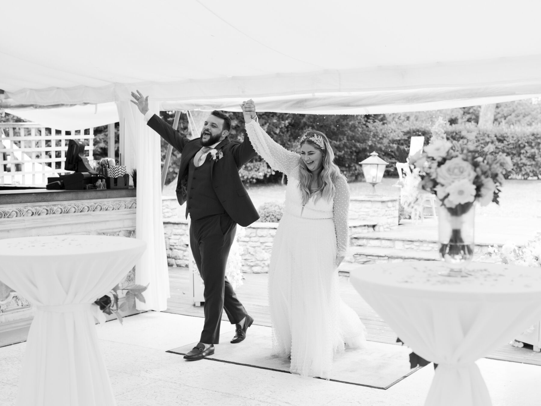 Bride and groom entering their wedding marquee to a round of applause