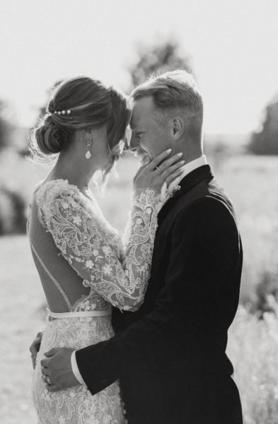 Black and white photography of intimate loving moment between bride and groom