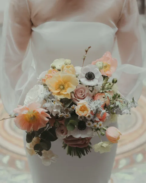 A beautiful pastel bridal bouquet. With Icelandic poppies, anemones, tulips and other spring flowers.