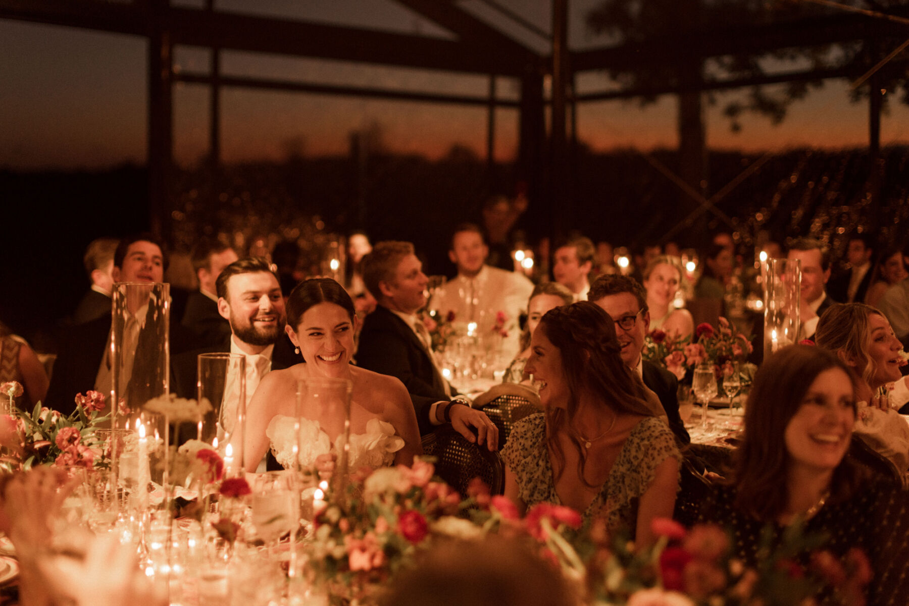 Warm lighting inside a modern glasshouse wedding venue