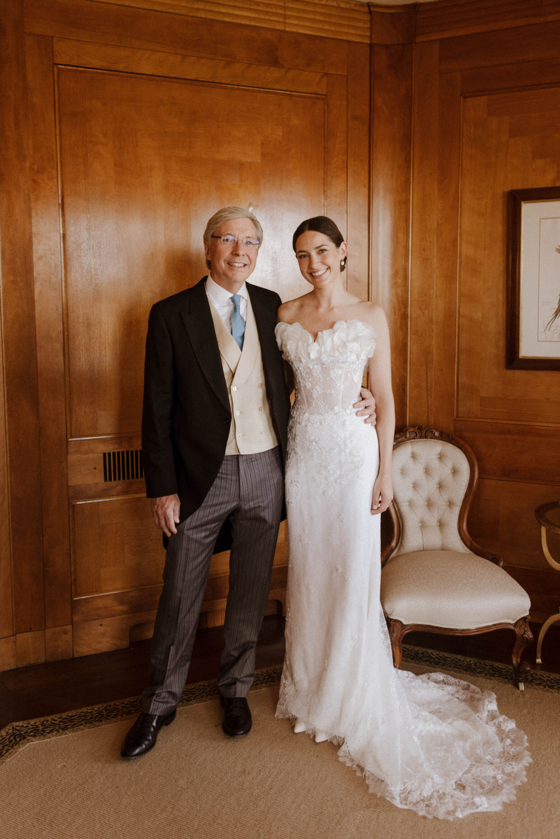 Father of the bride in traditional morning suit standing with his daughter who wears a Sally Bean Couture wedding dress. 