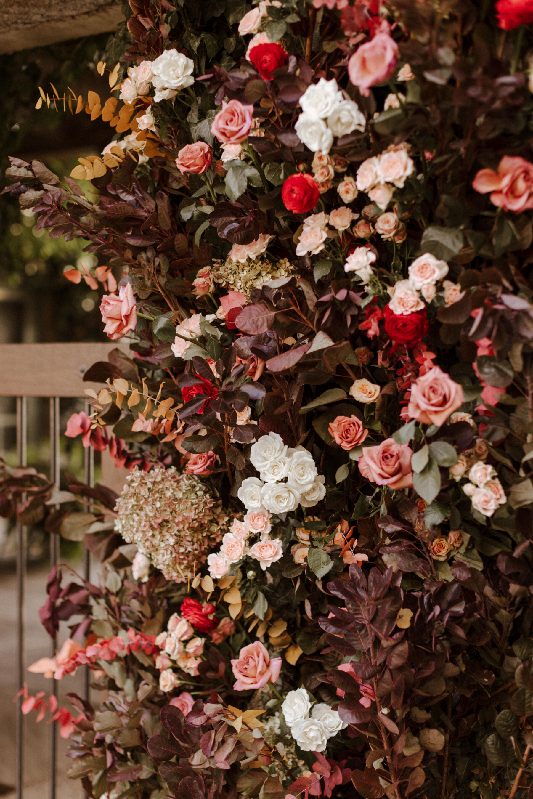Autumn wedding flowers forming part of a floral arch.