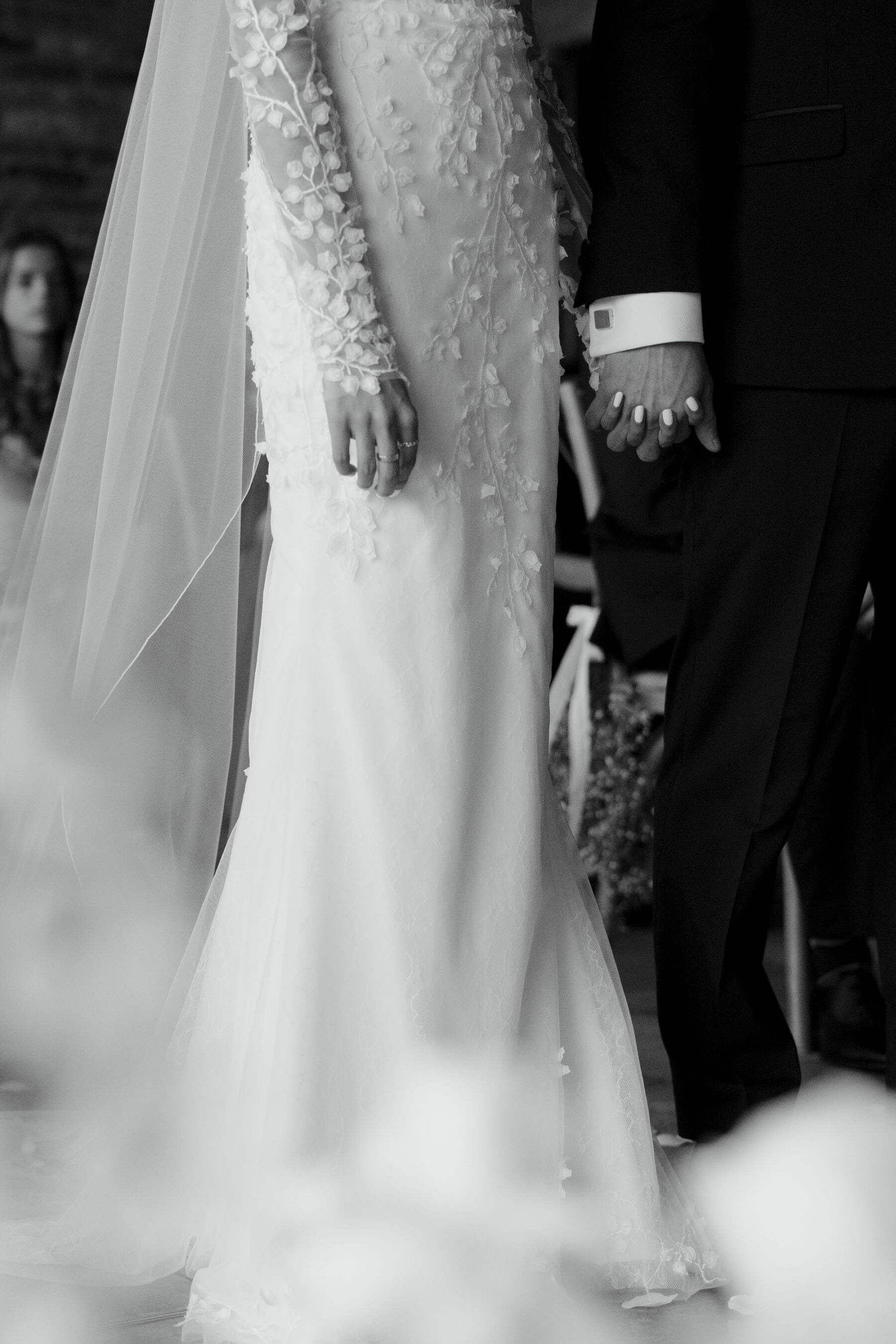  Bride and groom holding hands during their wedding ceremony