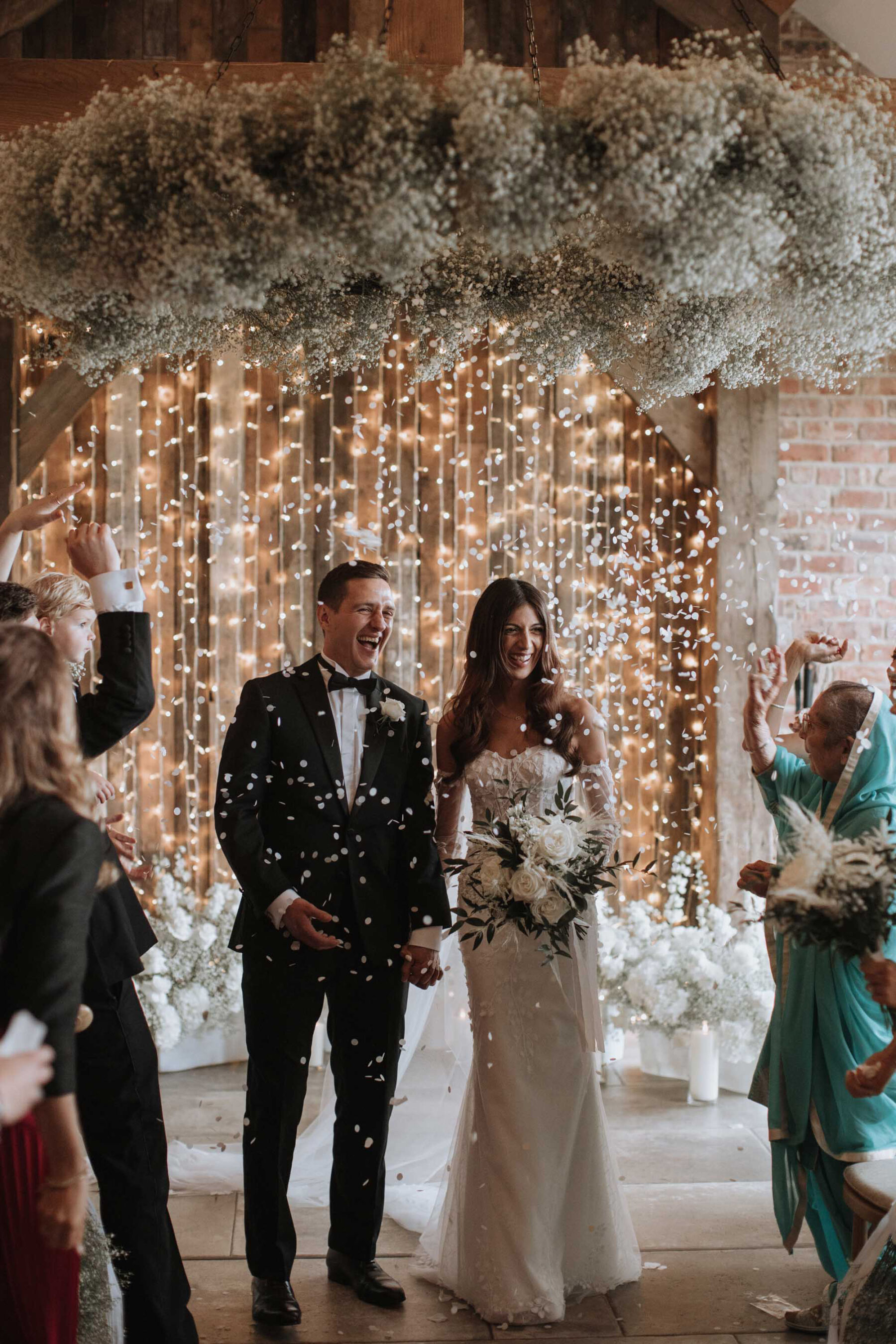 Bride and groom in a confetti shower at Thirsk Lodge Barns