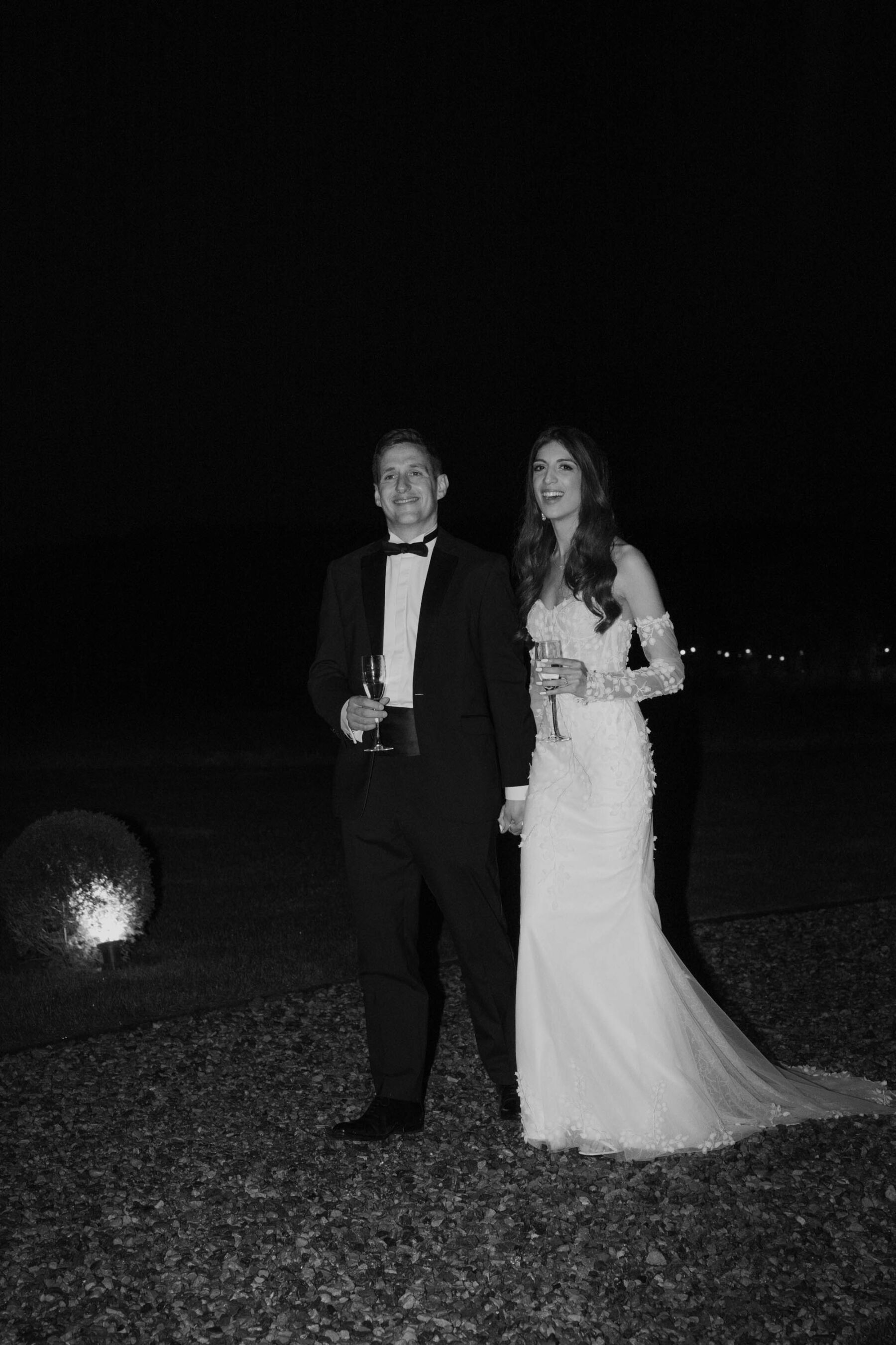 Bride and groom drinking champagne