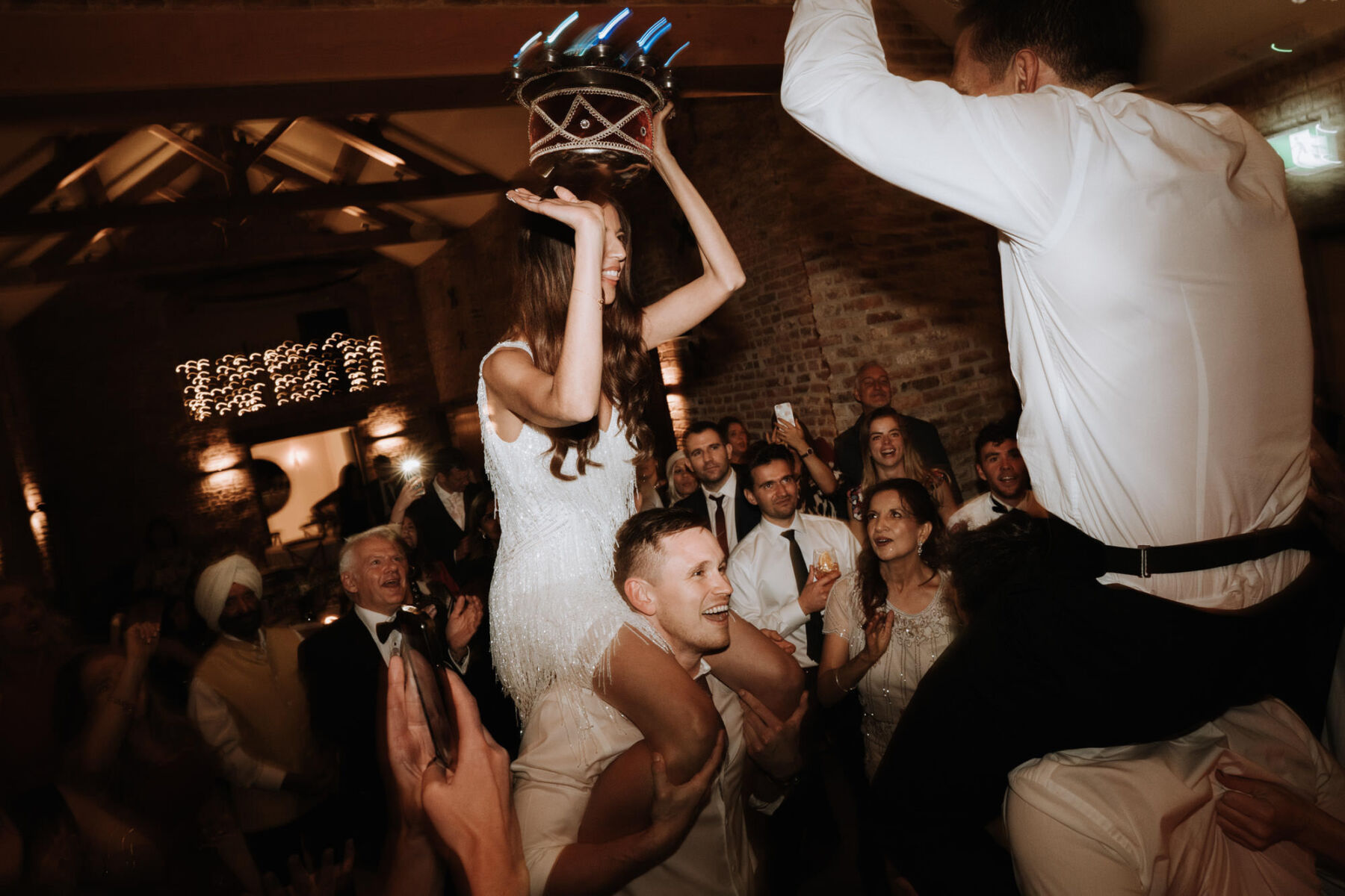 Bride dancing on a guests shoulder