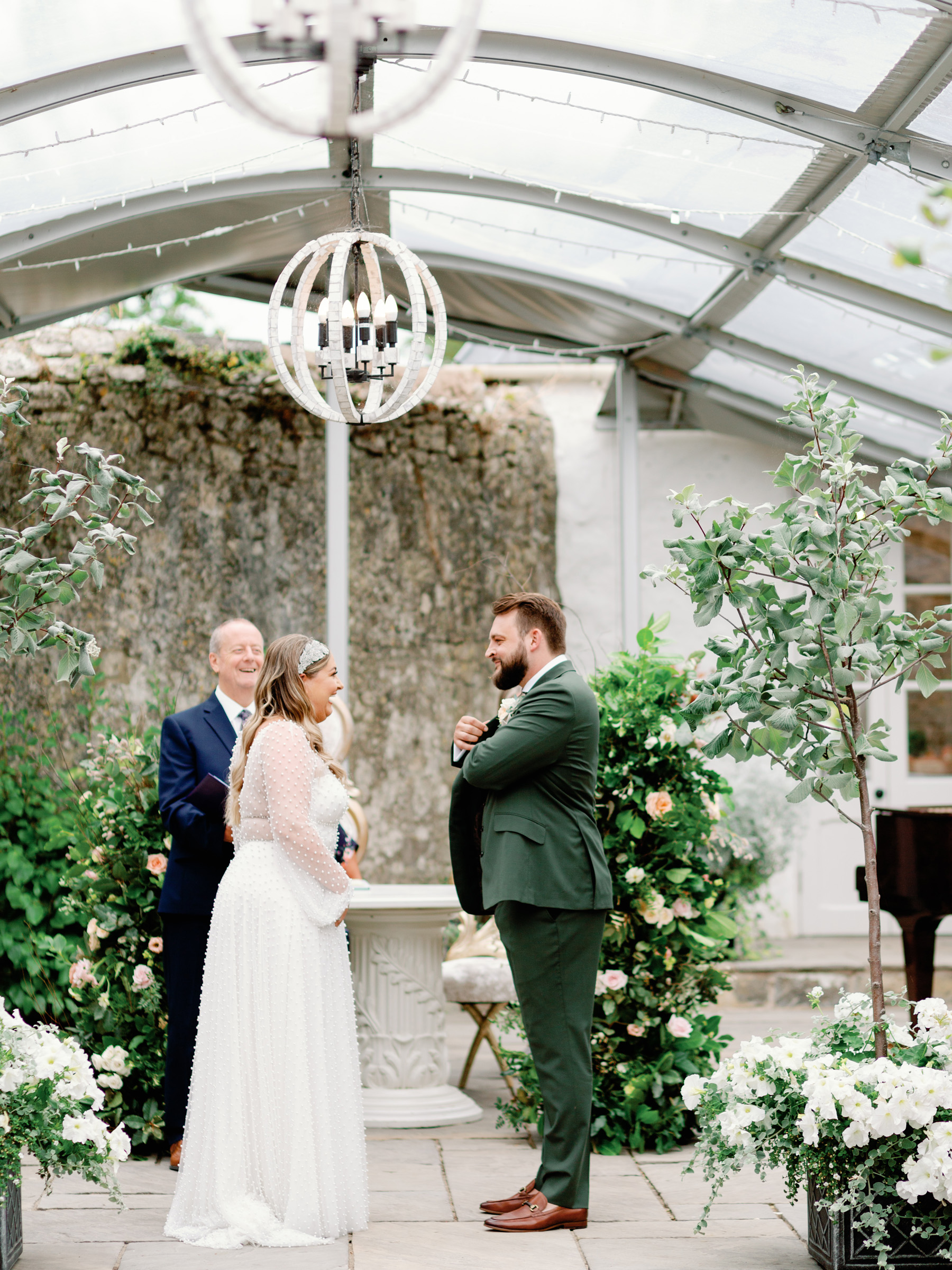 A Bridal Gown Covered in Pearls for a Nature Inspired Wedding at Gileston Manor in Wales 23 Bride and groom at their wedding ceremony with the officiant.