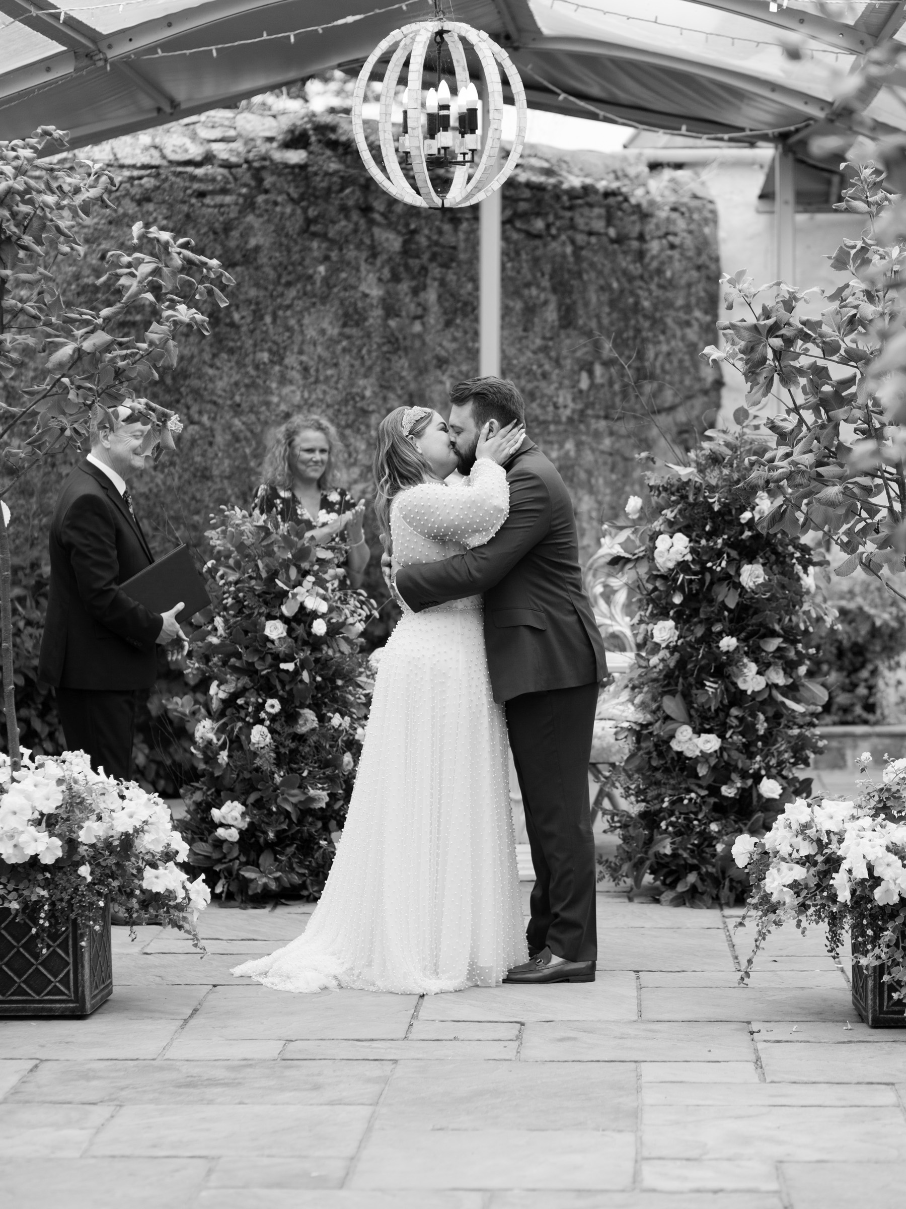 A Bridal Gown Covered in Pearls for a Nature Inspired Wedding at Gileston Manor in Wales 24 Bride and groom kissing at the end of their ceremony