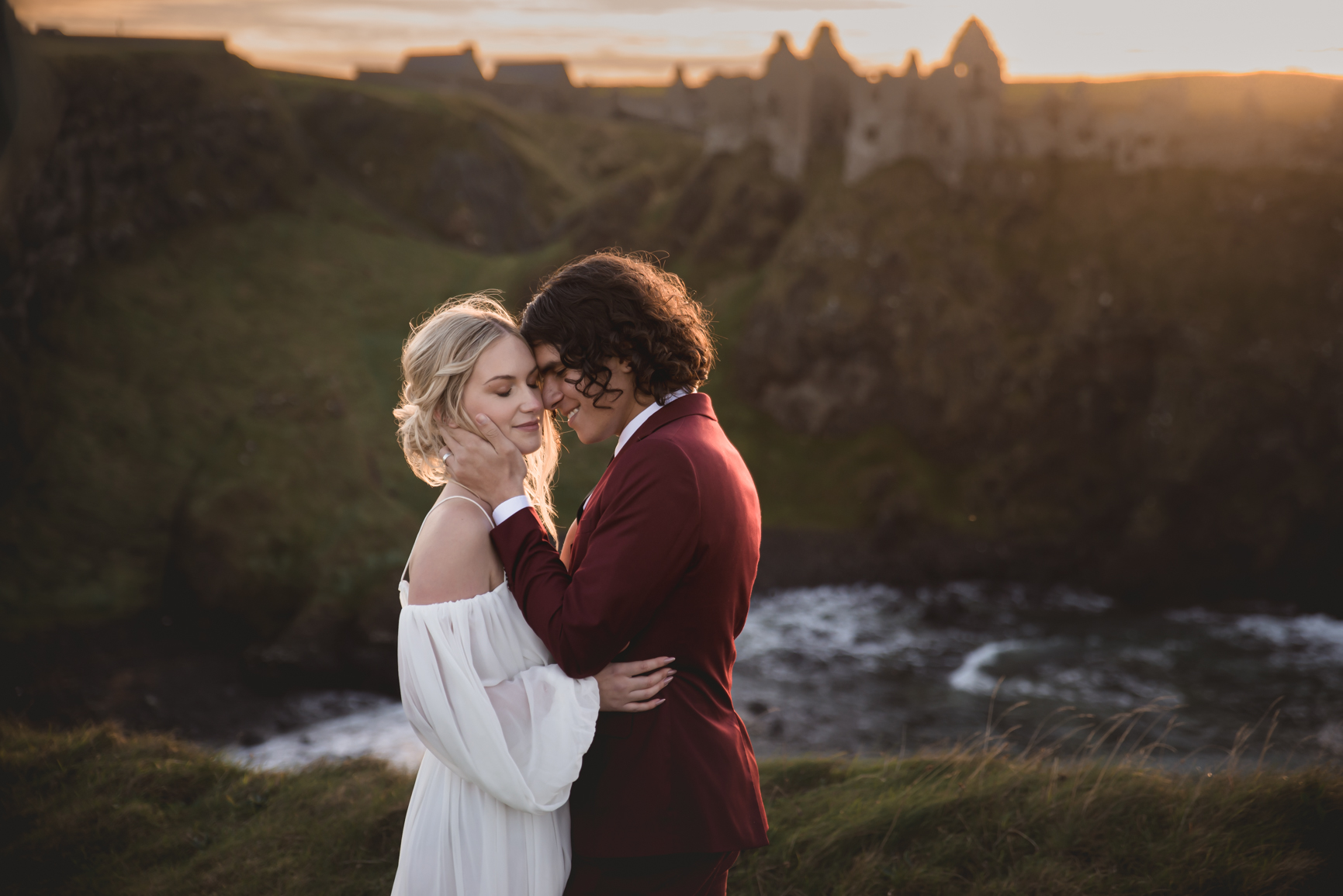 Lake District Wedding Photographer Anna Frances - Bride and Groom sharing a kiss on clifftop sunset scene