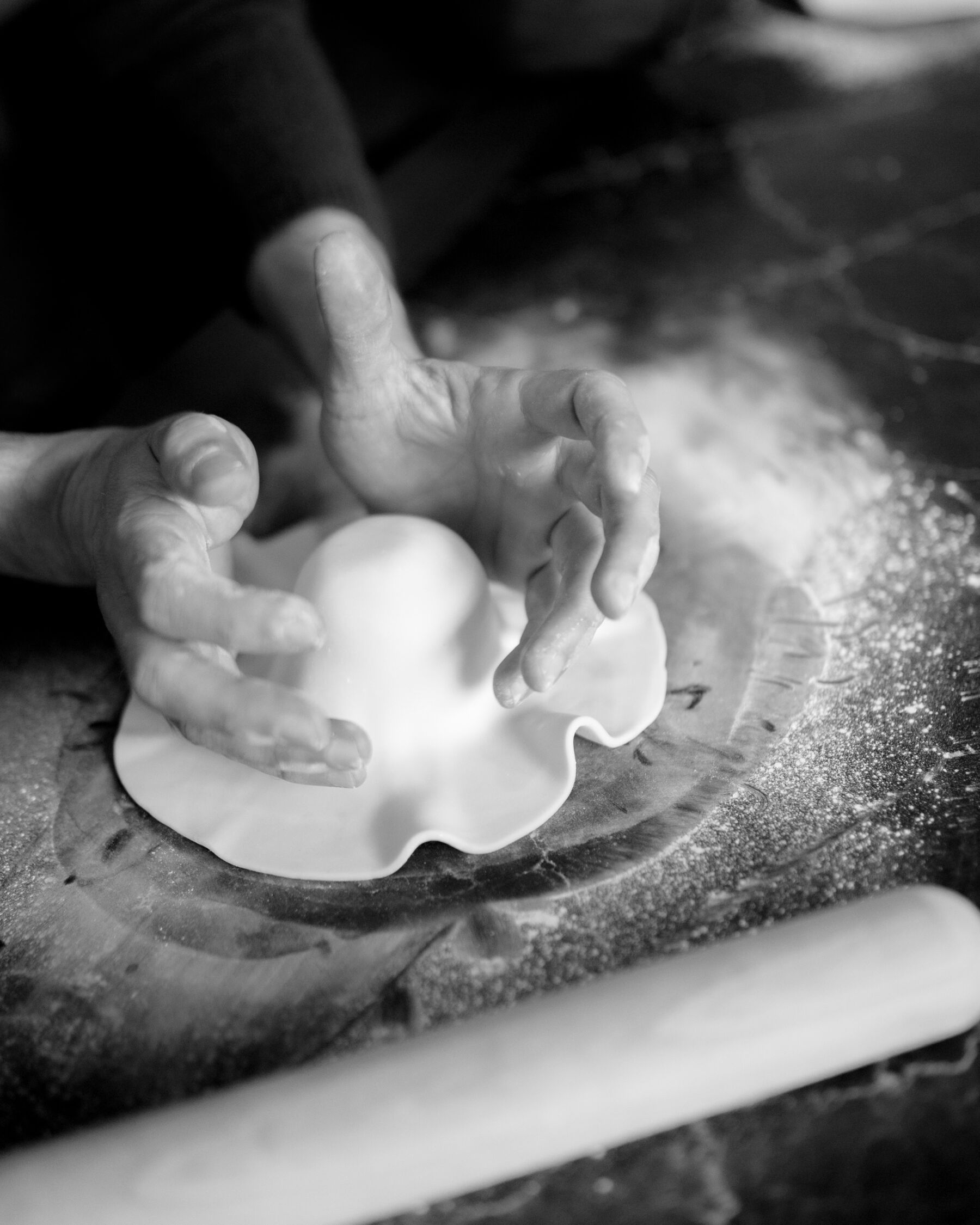 Hands working with  pastry.